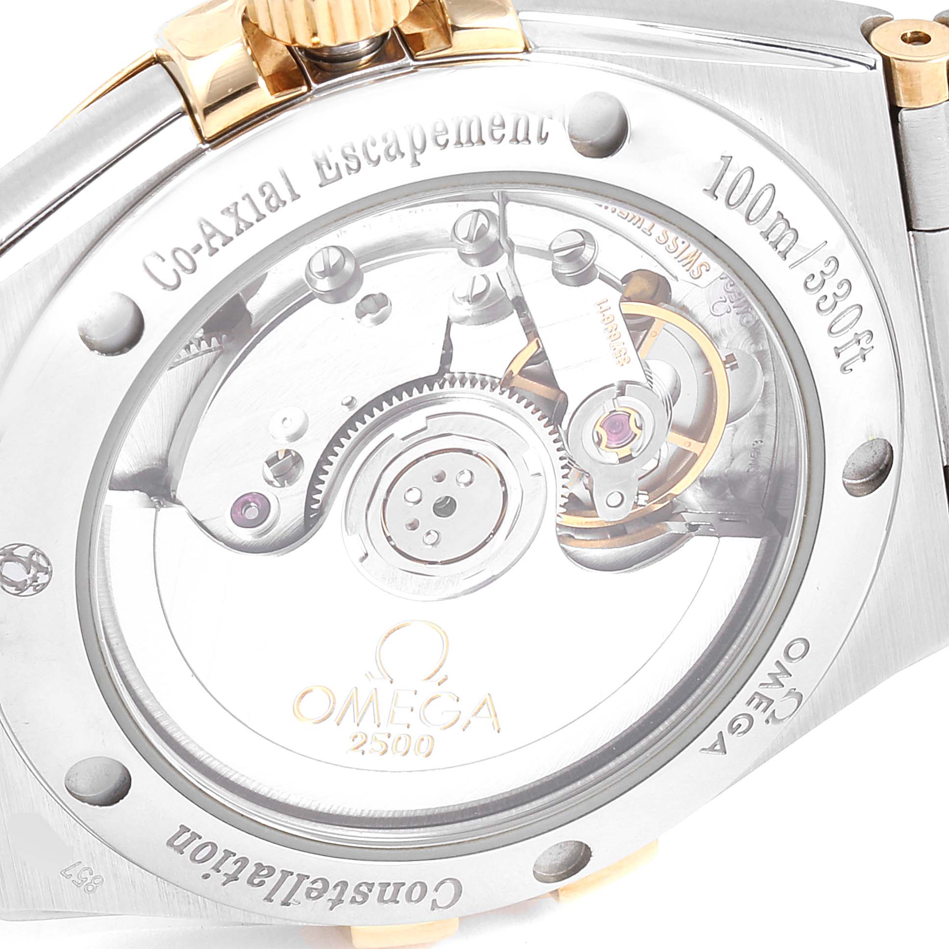 The image shows the back of the Omega Constellation 111.20.36.20.52.001 Men
s Steel and Gold (two tone) Silver Dial 111.20.36.20.52.001 Men
s Steel and Gold (two tone) Silver Dial watch, highlighting its movement with "Co-Axial Escapement" and 100m water resistance.