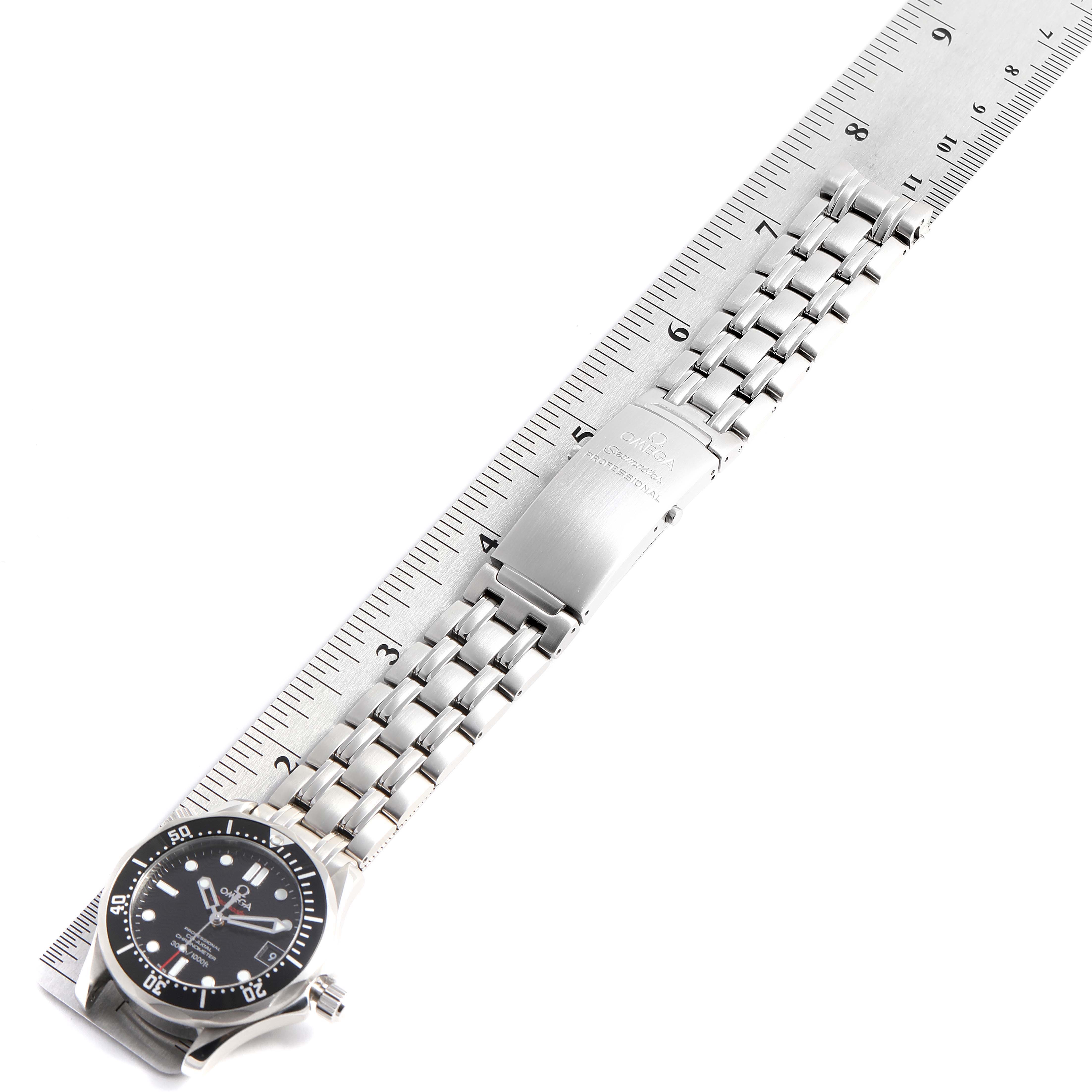 The Omega Seamaster 212.30.36.20.01.001 Men's Stainless Steel Black Dial 212.30.36.20.01.001 Men's Stainless Steel Black Dial watch is shown from a top-down angle, displaying its face, bracelet, and clasp alongside a ruler.