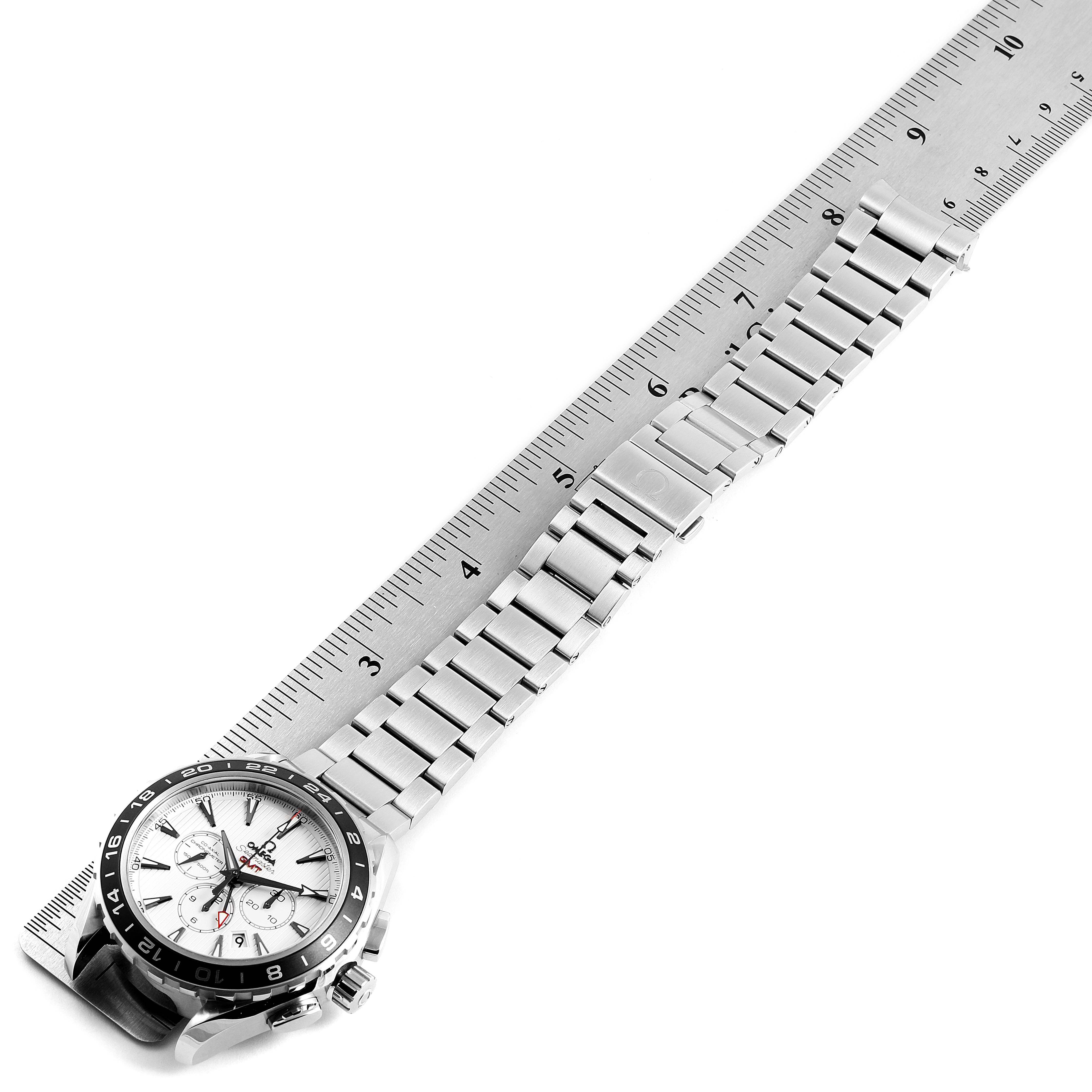 The image shows an Omega Seamaster 231.10.44.52.04.001 Men's Stainless Steel White Dial 231.10.44.52.04.001 Men's Stainless Steel White Dial watch laid next to a ruler, displaying the watch face and the metal bracelet.
