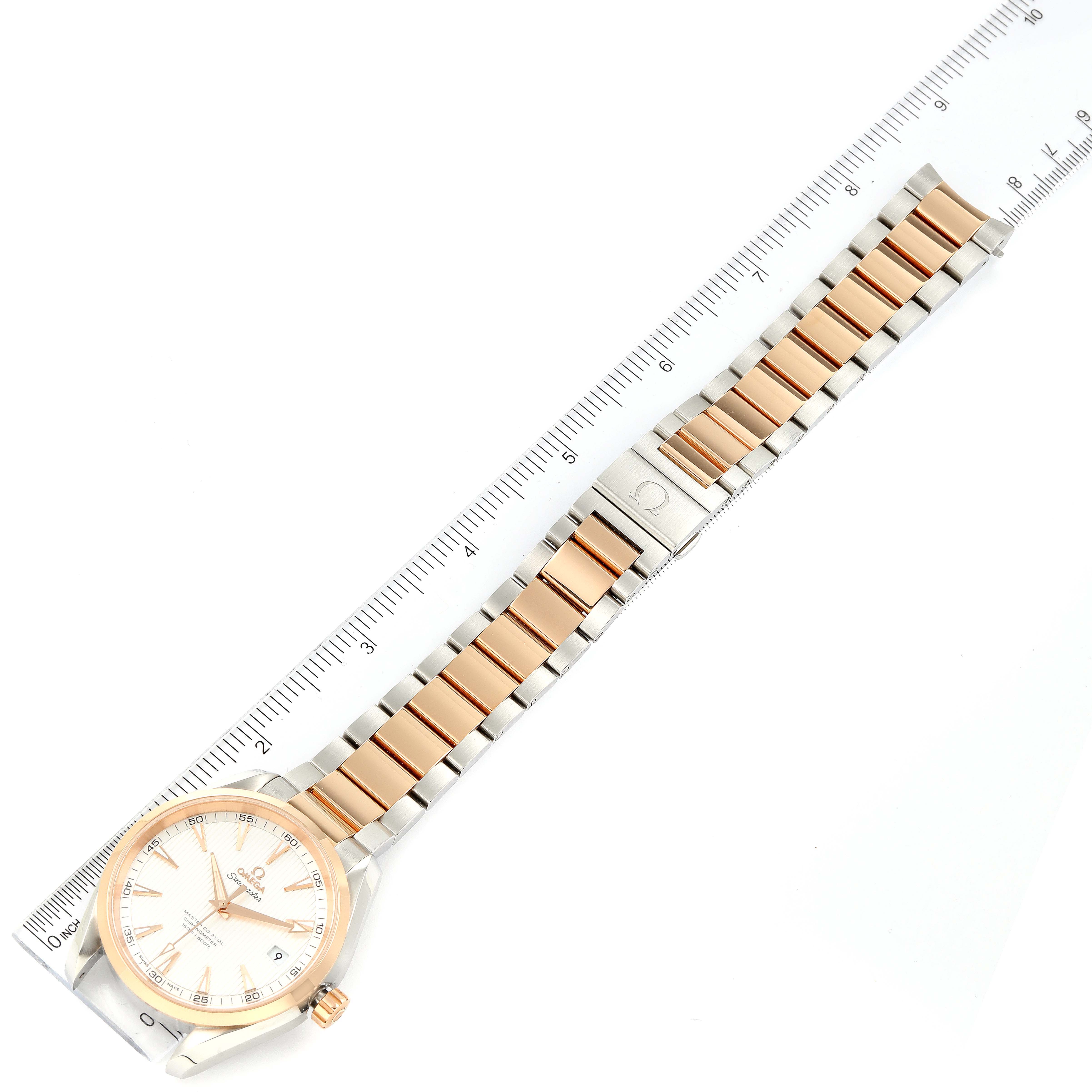 The image shows the Omega Aqua Terra 231.20.42.21.02.001 Men
s Steel and Gold (two tone) Silver Dial 231.20.42.21.02.001 Men
s Steel and Gold (two tone) Silver Dial watch laid flat with its entire bracelet and dial visible, alongside a measurement ruler.
