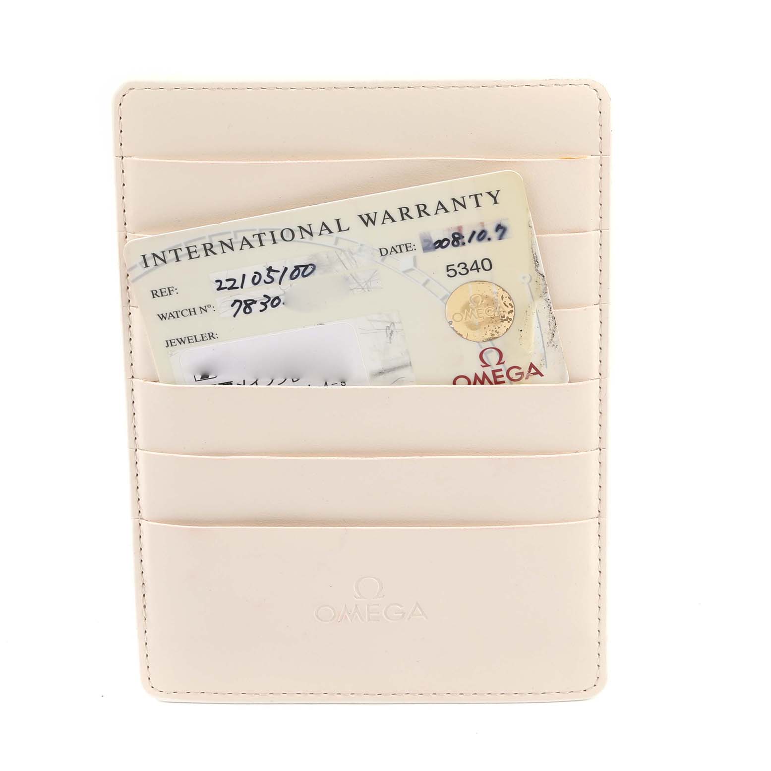 The image shows an International Warranty card inside a light-colored Omega cardholder for the Planet Ocean model.
