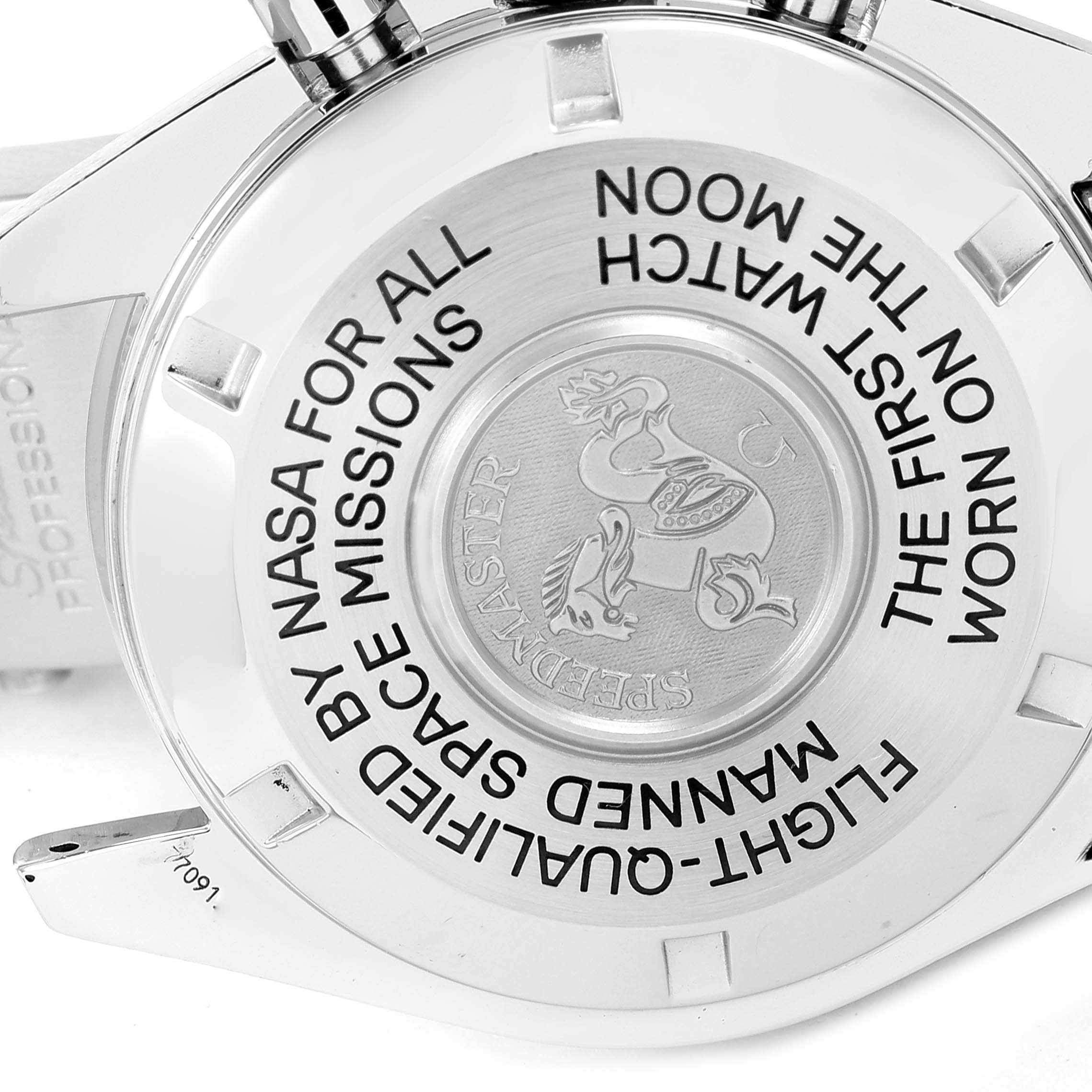 The image shows the case back of an Omega Speedmaster 3575.20.00 Men
s Stainless Steel White Dial 3575.20.00 Men
s Stainless Steel White Dial watch with engraved text and an emblem.