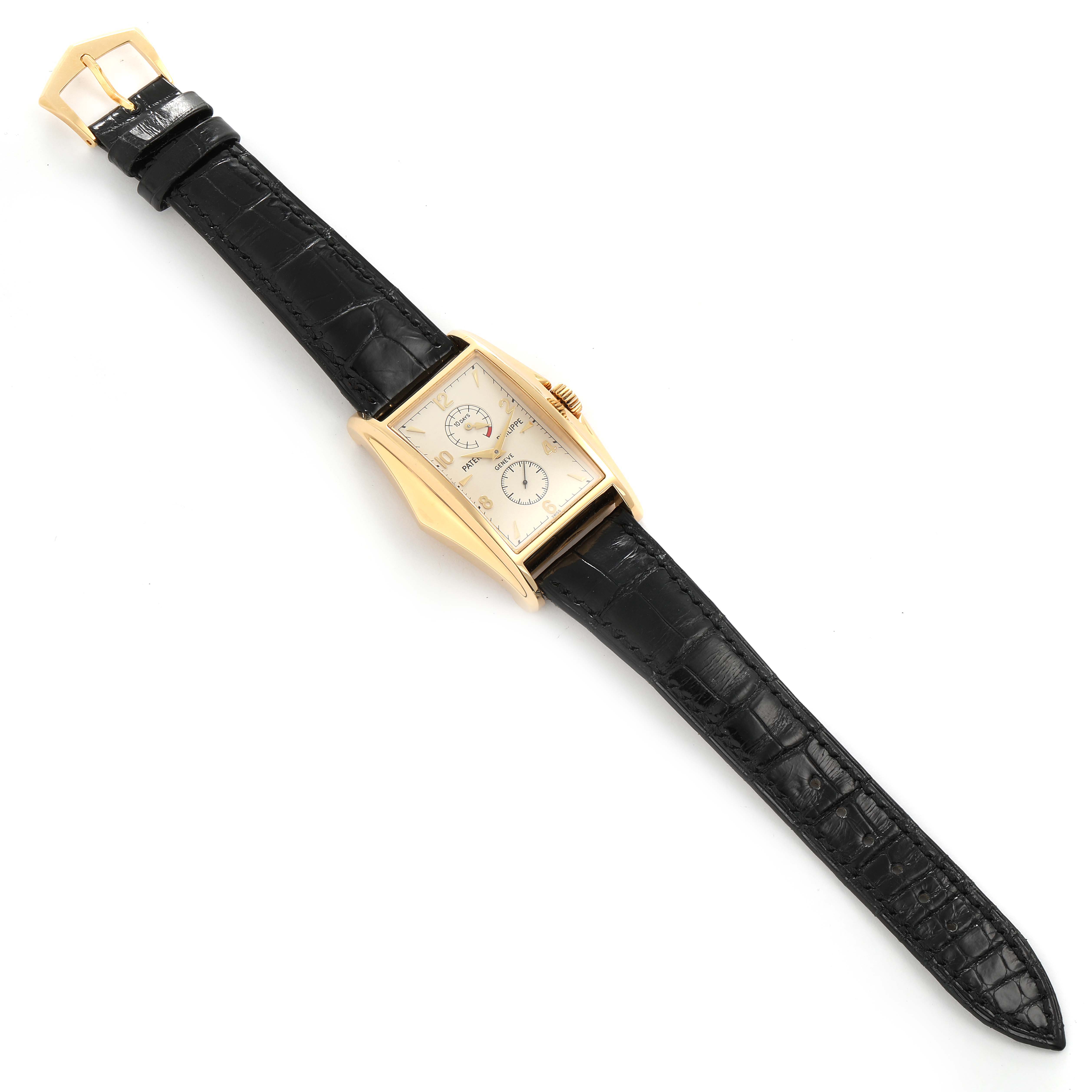 The image shows a Patek Philippe Gondolo 5100J Men's Yellow Gold Silver Dial 5100J Men's Yellow Gold Silver Dial watch from a top-down angle, highlighting its gold case and black leather strap.