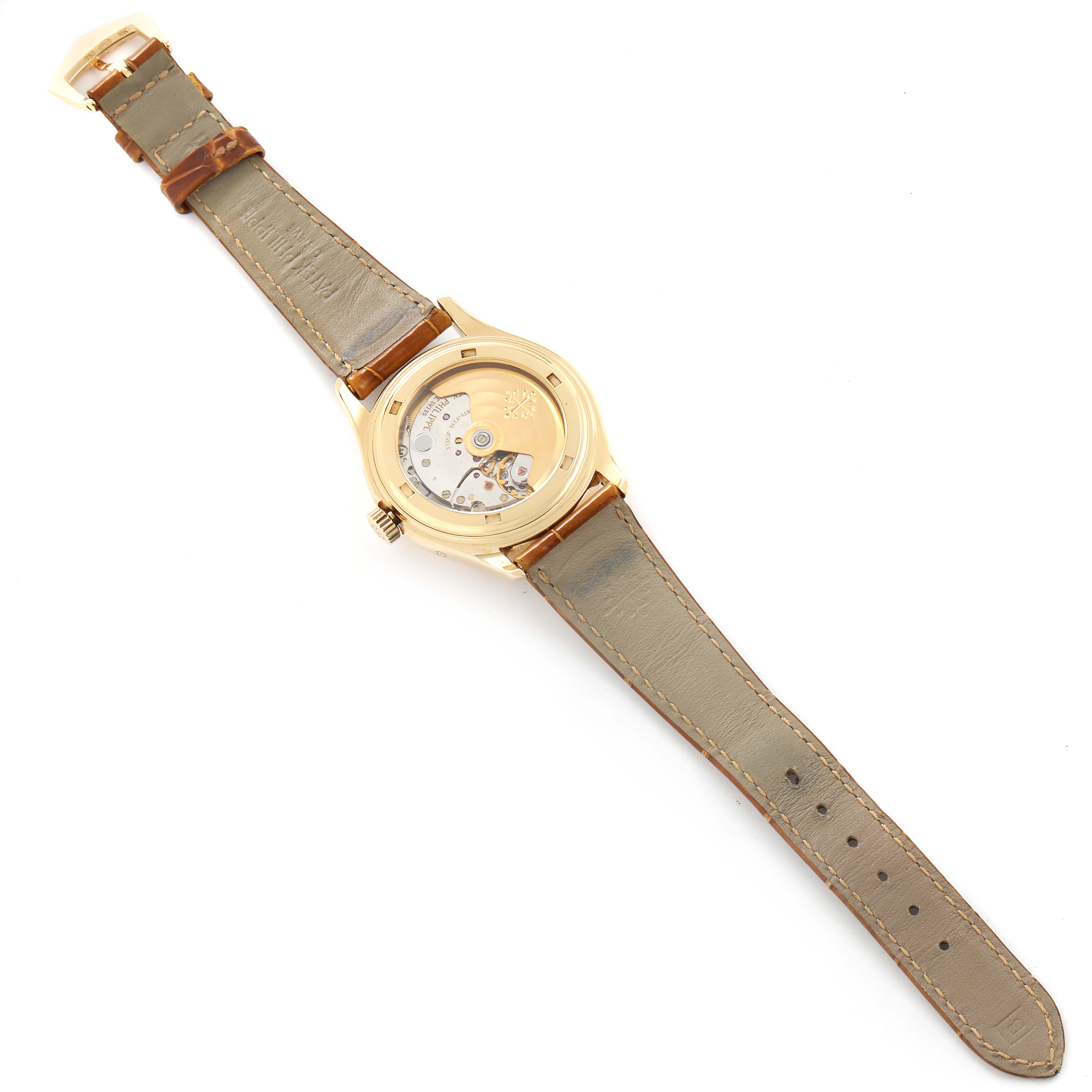 The image shows the backside of a Patek Philippe 5035 Men's Yellow Gold Silver Dial 5035 Men's Yellow Gold Silver Dial Complicated Annual Calendar Yellow Gold Mens Watch 5035, highlighting its open case back and leather strap.