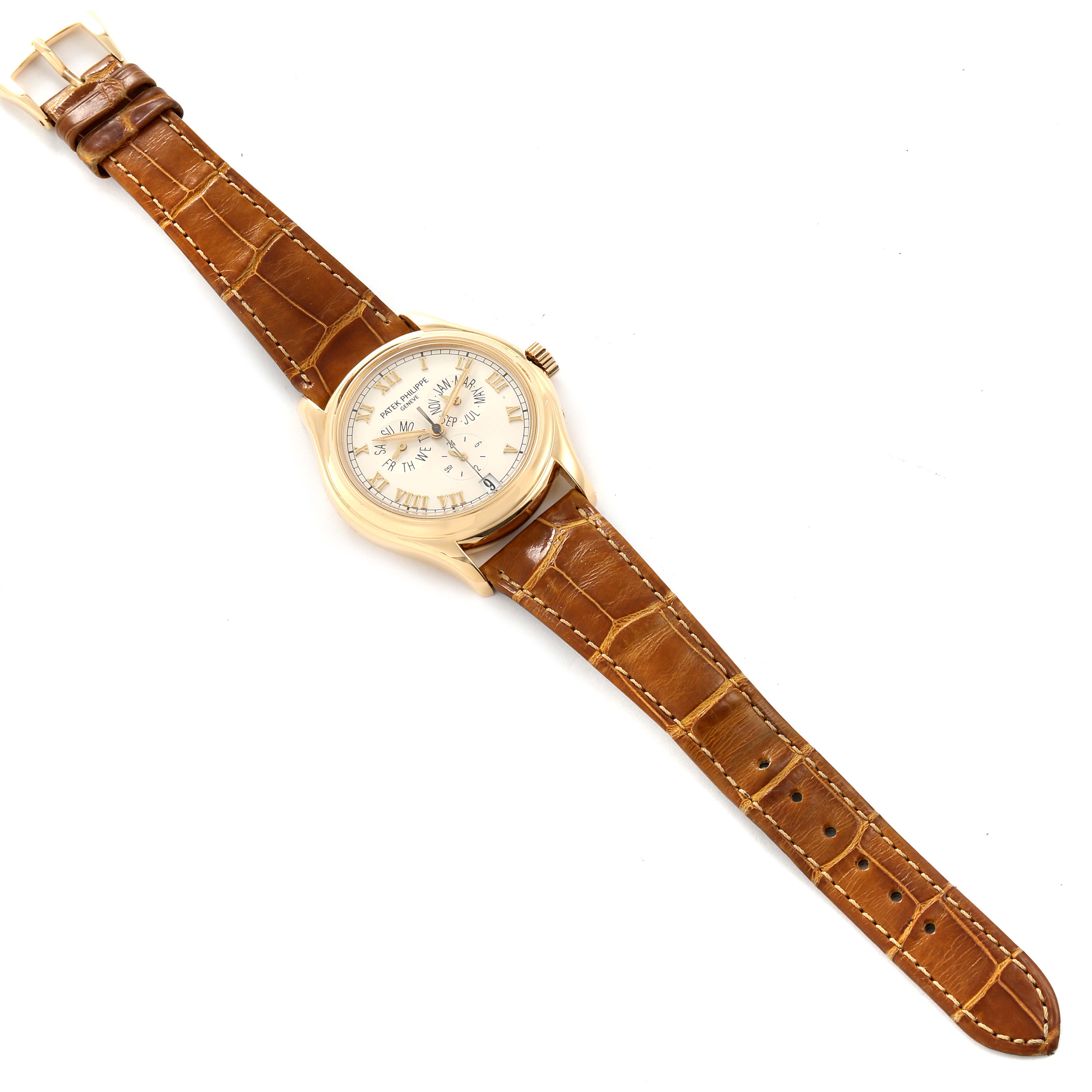 The image shows a top-down view of a Patek Philippe 5035 Men's Yellow Gold Silver Dial 5035 Men's Yellow Gold Silver Dial Complicated Annual Calendar Yellow Gold Men's Watch 5035, including the face, case, and leather strap.