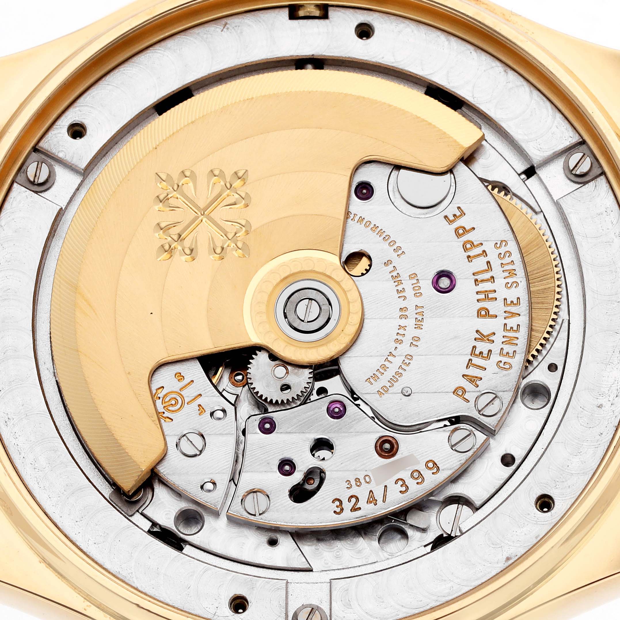 The image shows the intricate movement of a Patek Philippe Complications 5146J Men
s Yellow Gold Beige Dial model from the back, highlighting the oscillating weight and internal mechanisms.