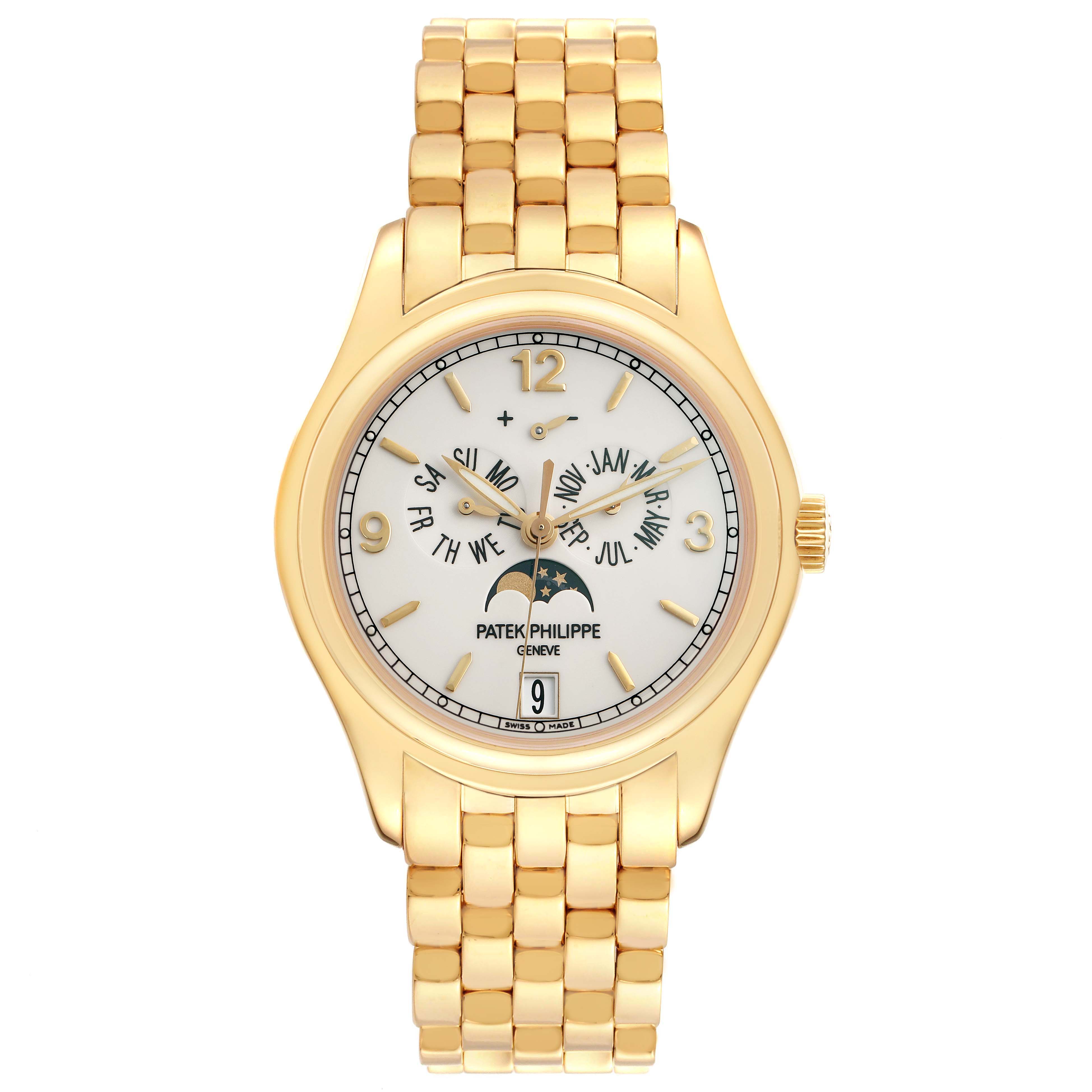 The Patek Philippe Complications 5146J Men
s Yellow Gold Beige Dial watch is shown from a top-down angle, highlighting its face, bracelet, and crown.