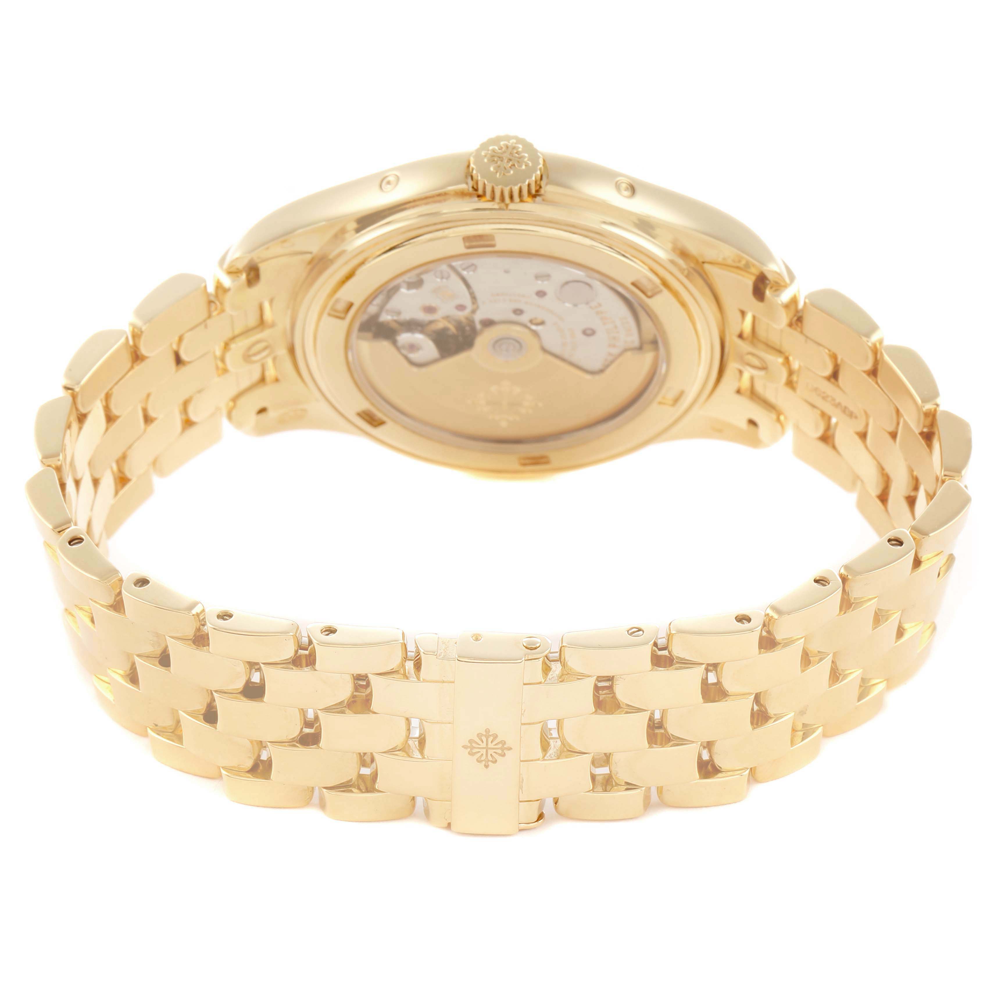The Patek Philippe Complications 5146J Men
s Yellow Gold Beige Dial model is shown from the back, featuring the open case back and gold bracelet.