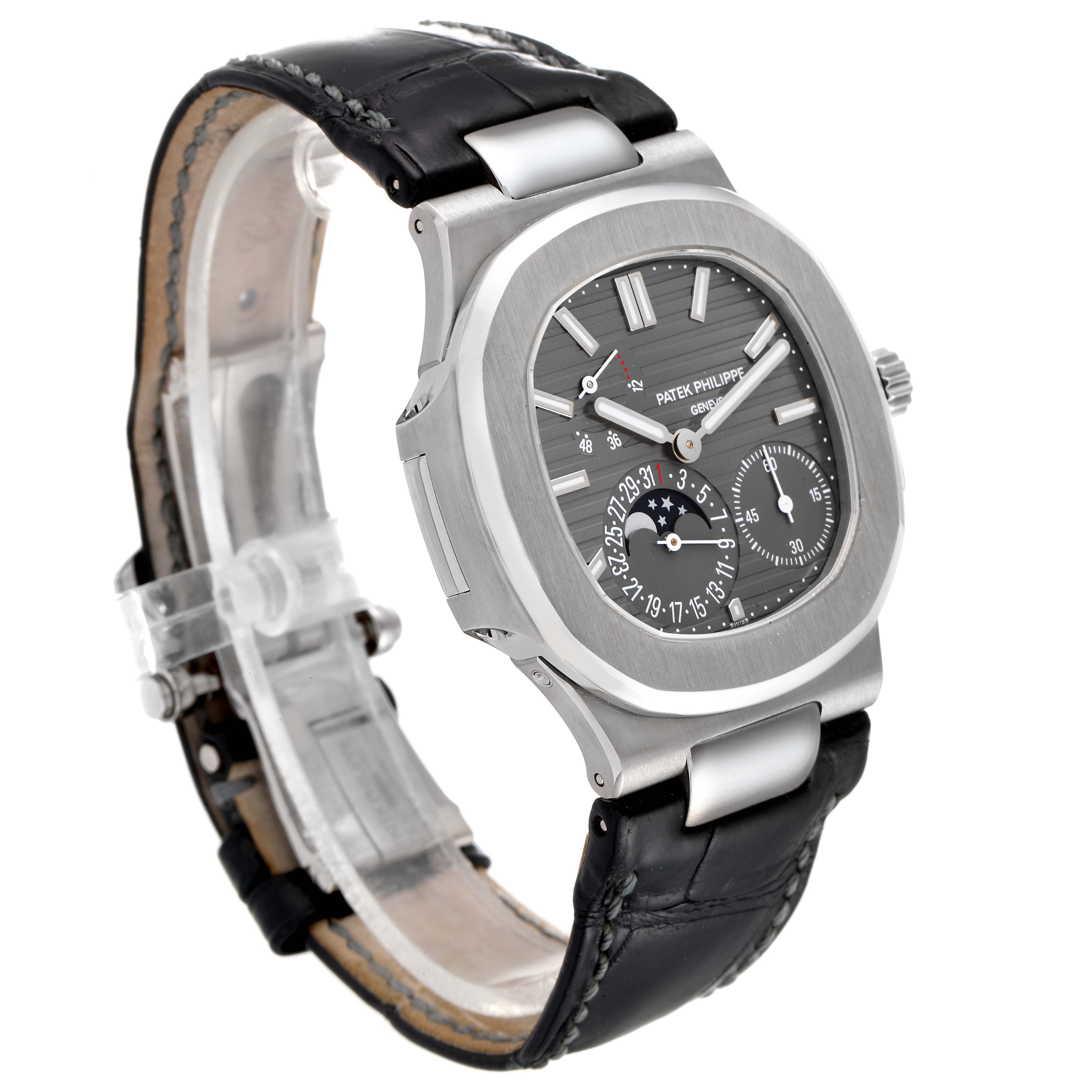 The image shows a side-angle view of a Patek Philippe Nautilus 5712G/001 Men's White Gold Grey Dial 5712G/001 Men's White Gold Grey Dial watch, featuring its dial, bezel, and black leather strap.