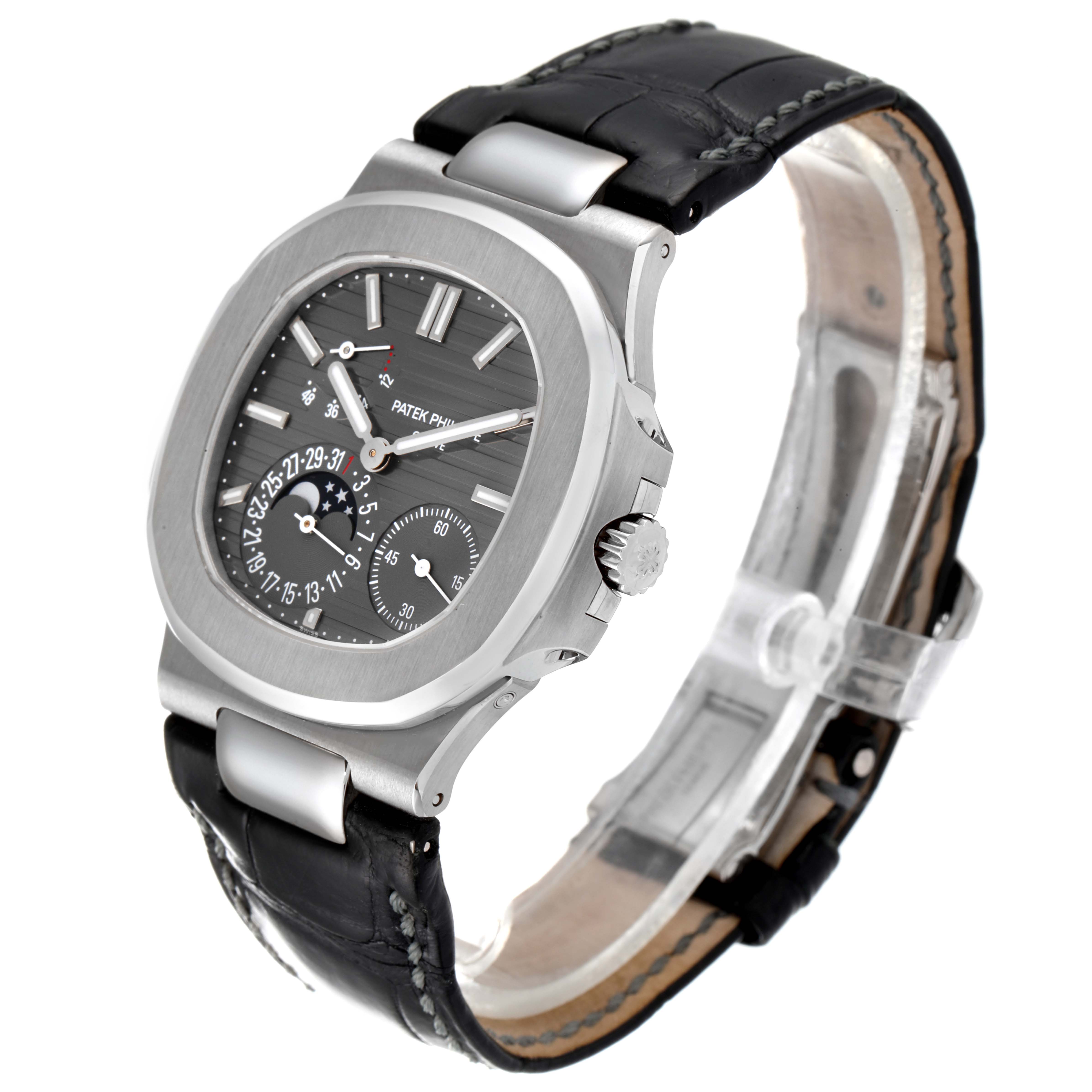 This image shows a side angle view of the Patek Philippe Nautilus 5712G/001 Men's White Gold Grey Dial 5712G/001 Men's White Gold Grey Dial watch featuring its dial, case, crown, and black leather strap.