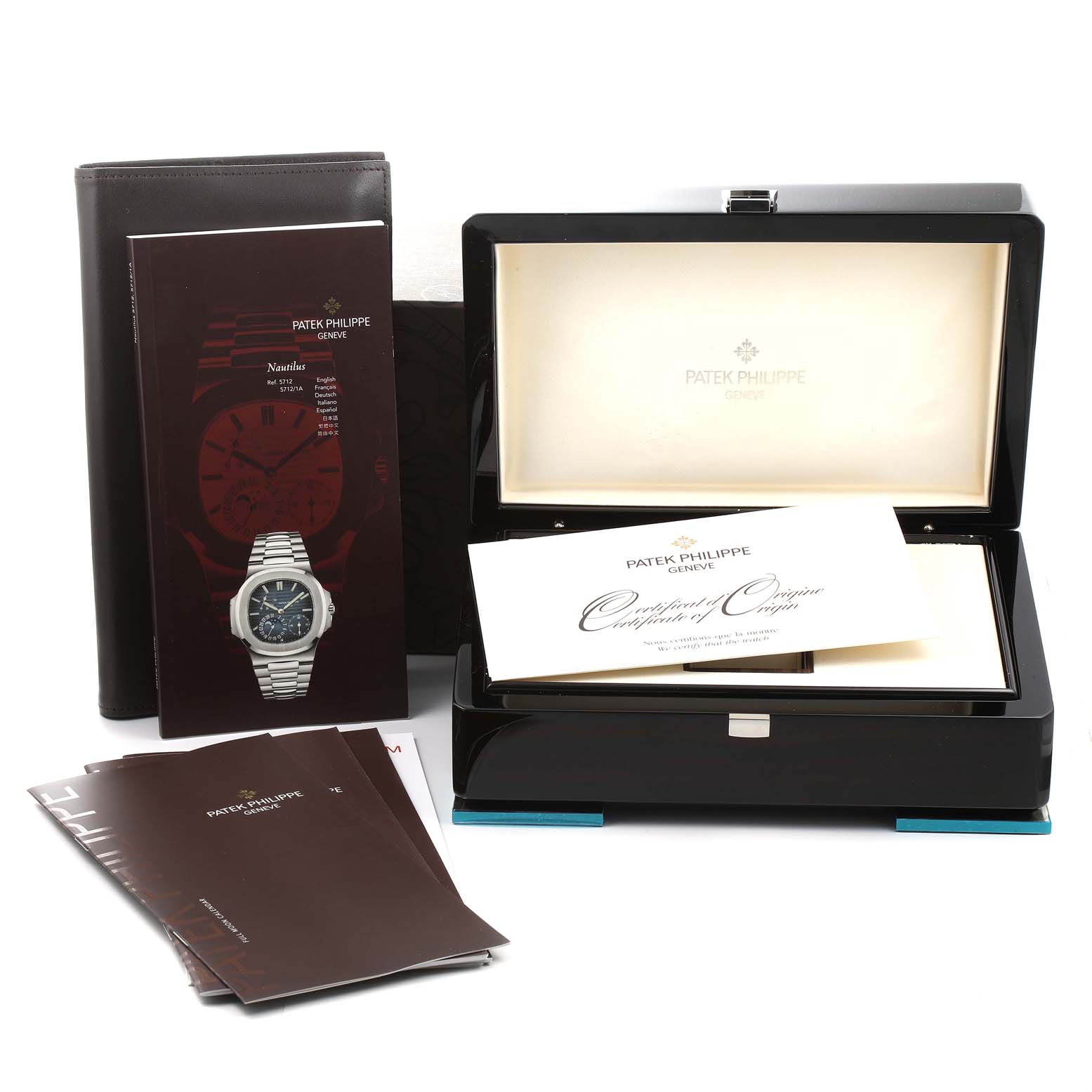 The image shows the packaging, owner manuals, and certificate of origin for a Patek Philippe Nautilus 5712G/001 Men's White Gold Grey Dial 5712G/001 Men's White Gold Grey Dial watch.