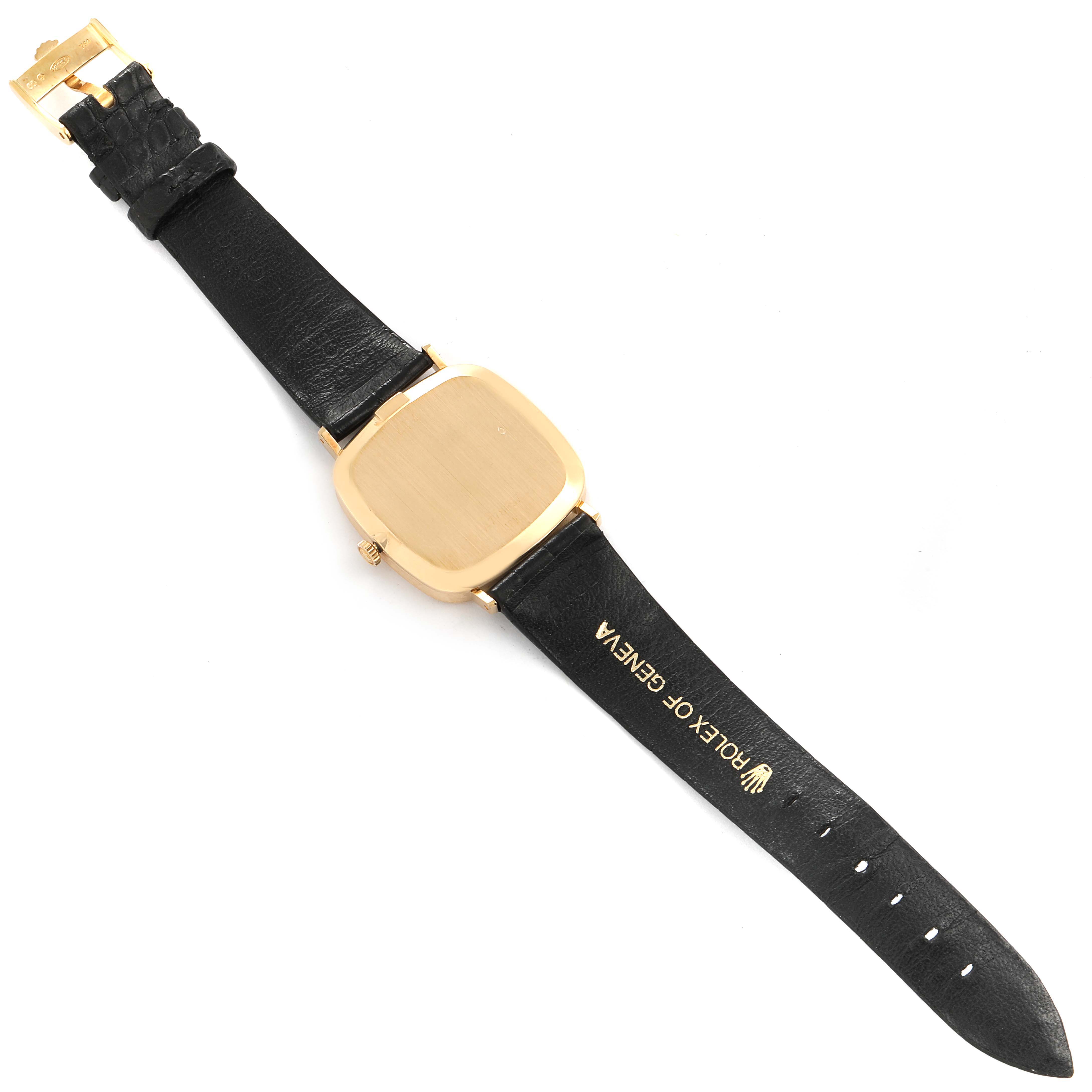 This image shows a Rolex Cellini 4114 Men's Yellow Gold Silver Dial 4114 Men's Yellow Gold Silver Dial watch from a top-down angle with its case back, strap, and buckle visible.