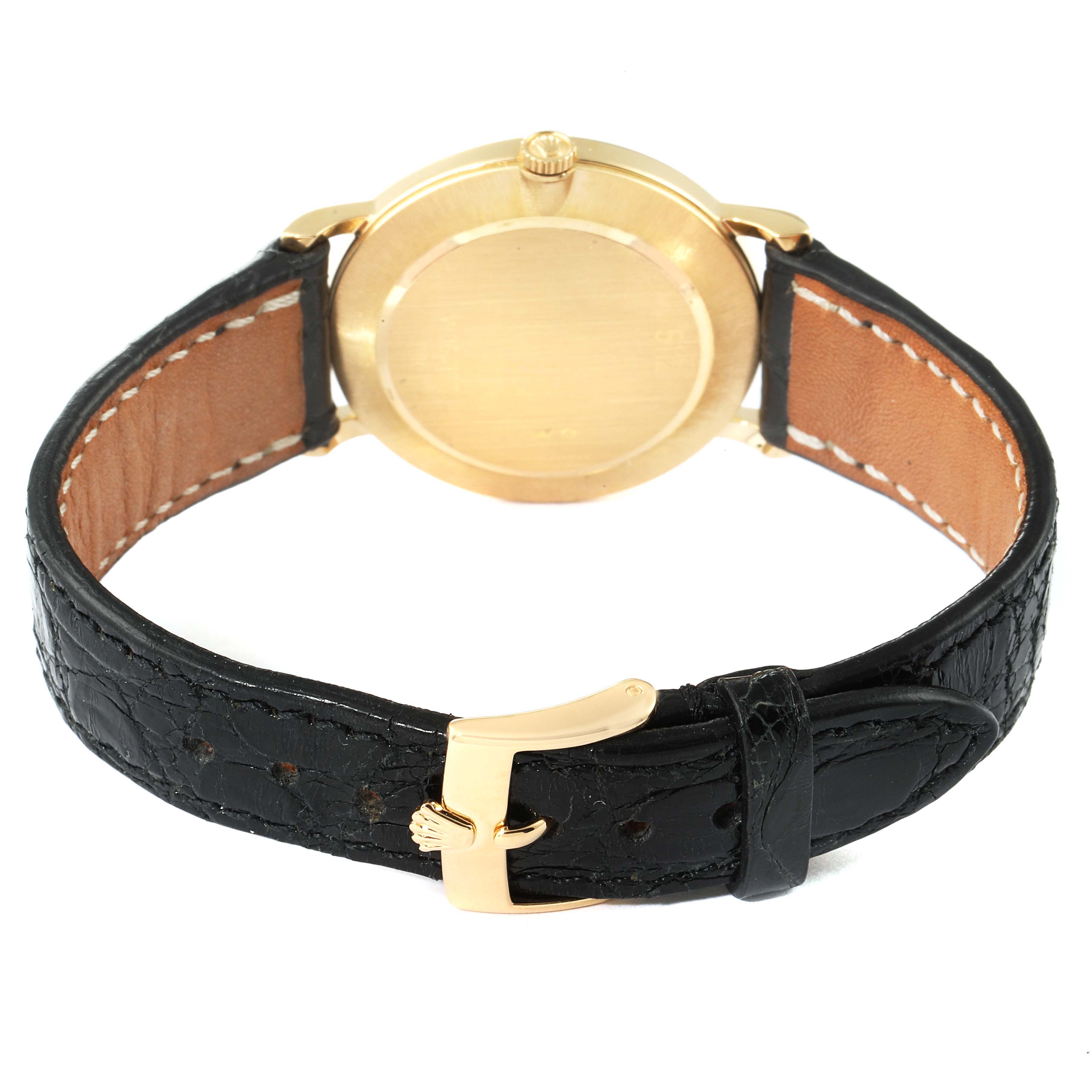 The image shows the back case and strap of a Rolex Cellini 5112 Men's Yellow Gold Beige Dial 5112 Men's Yellow Gold Beige Dial watch, with a focus on the watch's gold buckle and leather strap.