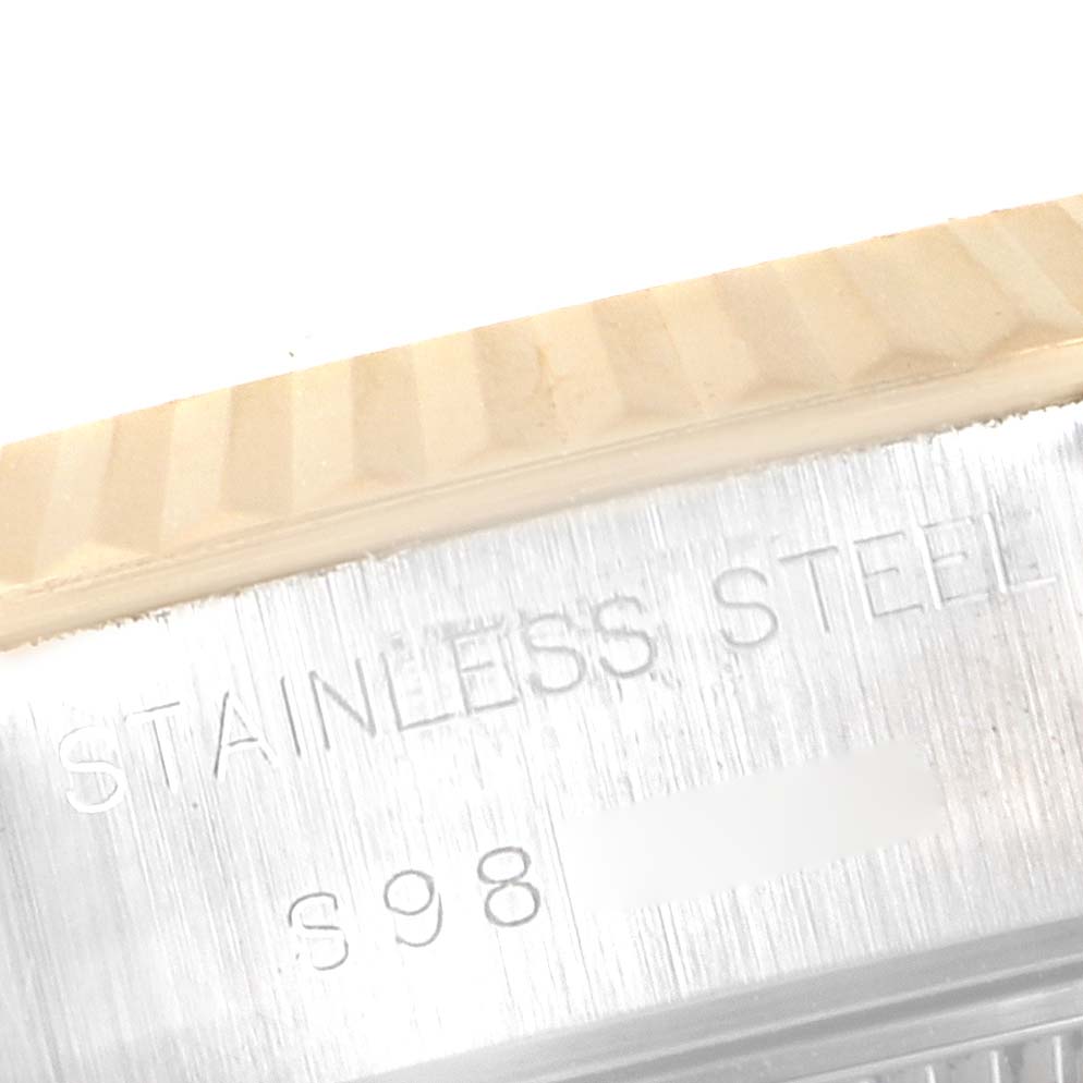 This close-up image shows the engraved text on the side of the stainless steel case of a Rolex Datejust 69173 Women's Steel and Gold (two tone) Champagne Dial 69173 Women's Steel and Gold (two tone) Champagne Dial watch.