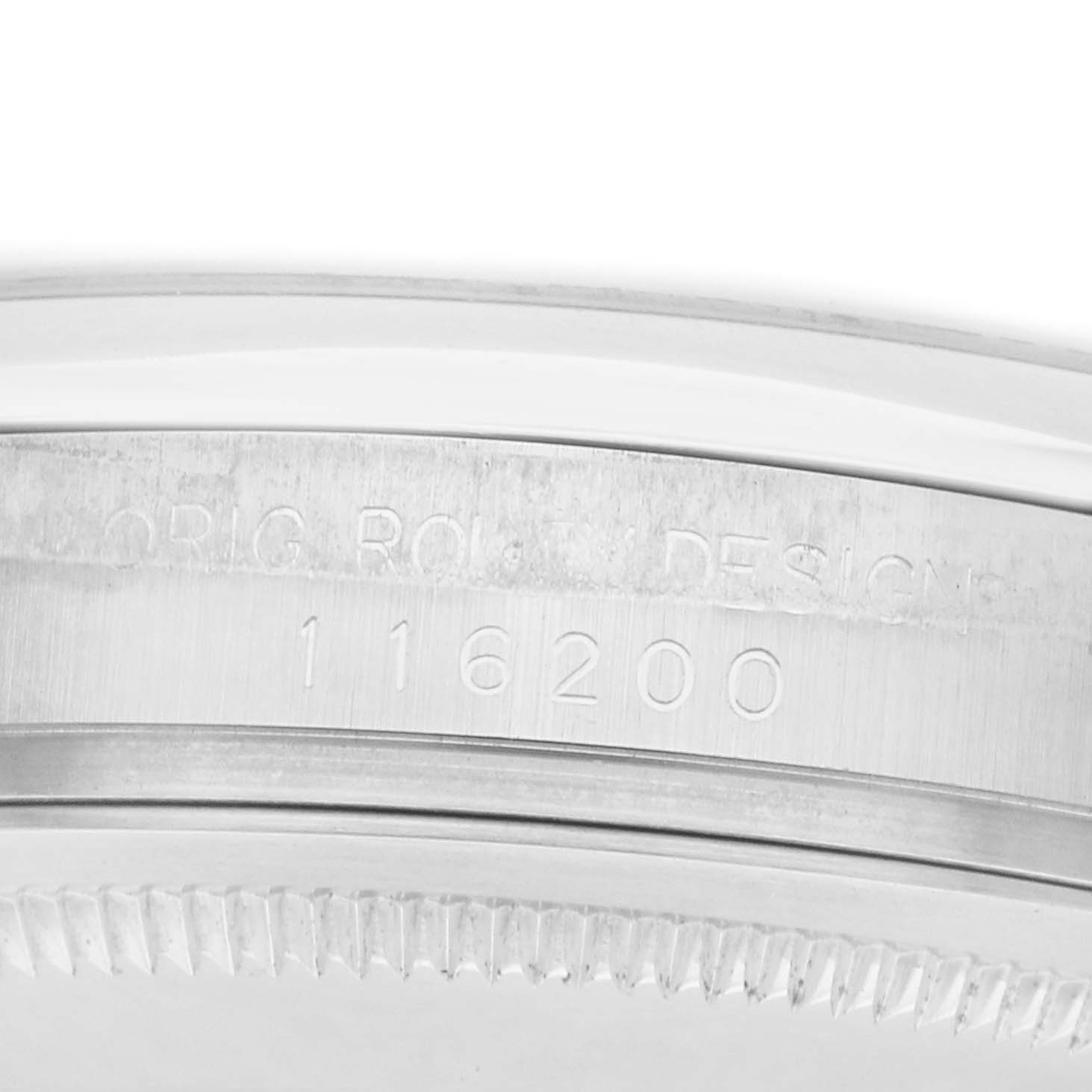 The image shows the side view of a Rolex Datejust 116200 Men's Stainless Steel Blue Dial watch case, highlighting the bezel and part of the casing with engraved details.