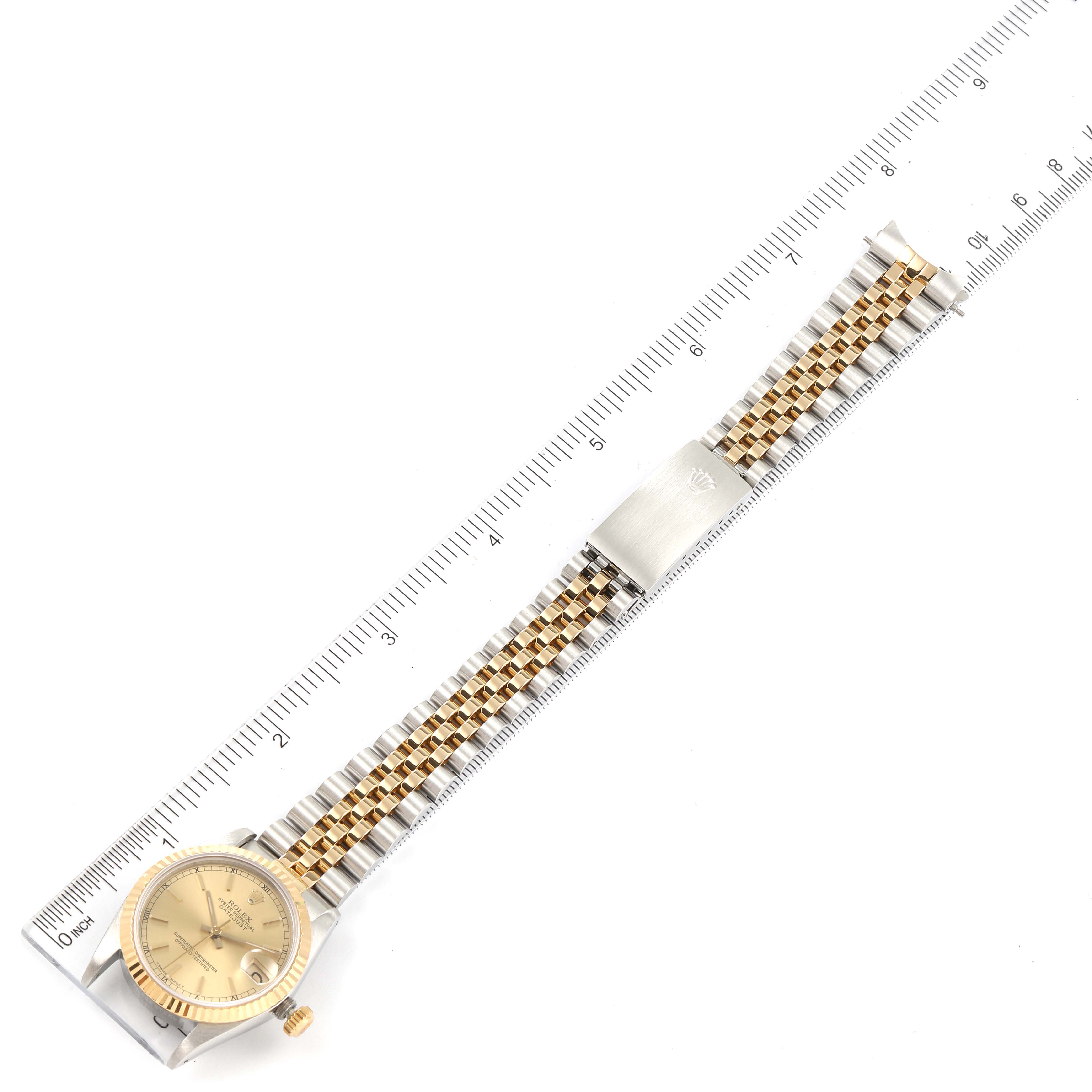 This image shows a Mid-Size Rolex watch with a gold dial and a two-tone jubilee bracelet, measured with a ruler.
