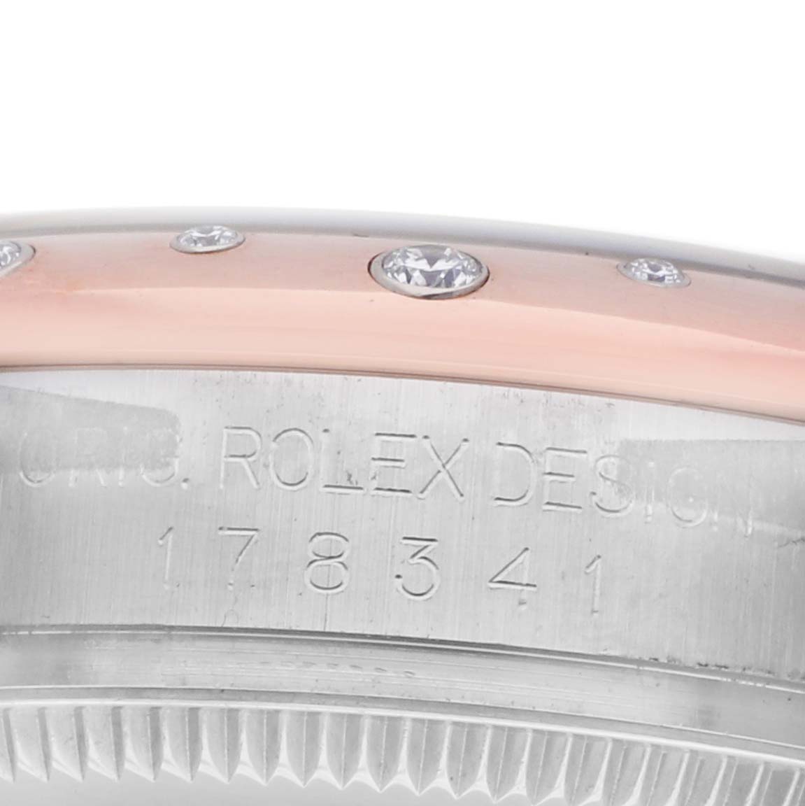 The image shows the side view of a Rolex Mid-Size 178341 Women's Steel and Gold (two tone) White Dial model, displaying its bezel adorned with diamonds and the engraved model number.