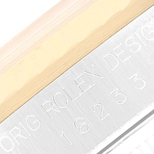 This image shows a macro shot of the case side engraving on a Rolex Datejust 16233 Men's Stainless Steel White Dial 16233 Men's Stainless Steel White Dial model.