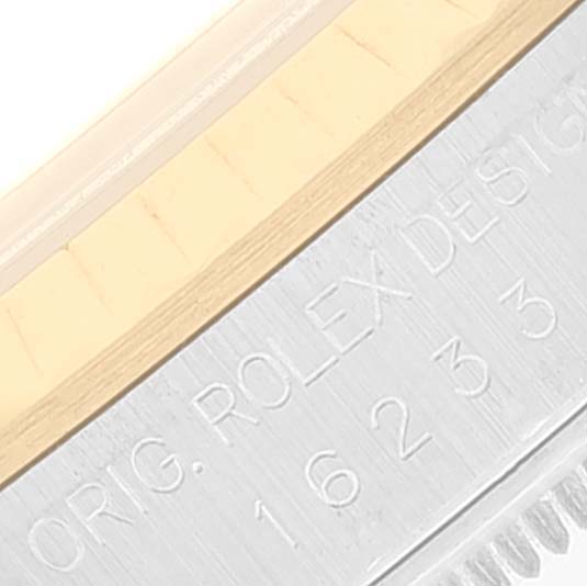 This image shows a close-up of the side, bezel, and engravings of a Rolex Datejust 16233 Men's Steel and Gold (two tone) Blue Dial 16233 Men's Steel and Gold (two tone) Blue Dial watch.
