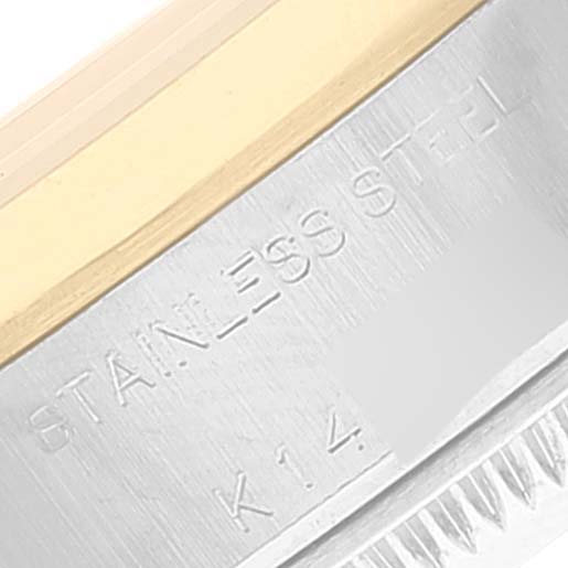 This close-up image shows the side engraving on the bezel of a Rolex Datejust 79163 Women's Steel and Gold (two tone) White Dial 79163 Women's Steel and Gold (two tone) White Dial watch, featuring text indicating it is made of stainless steel with 14K gold.
