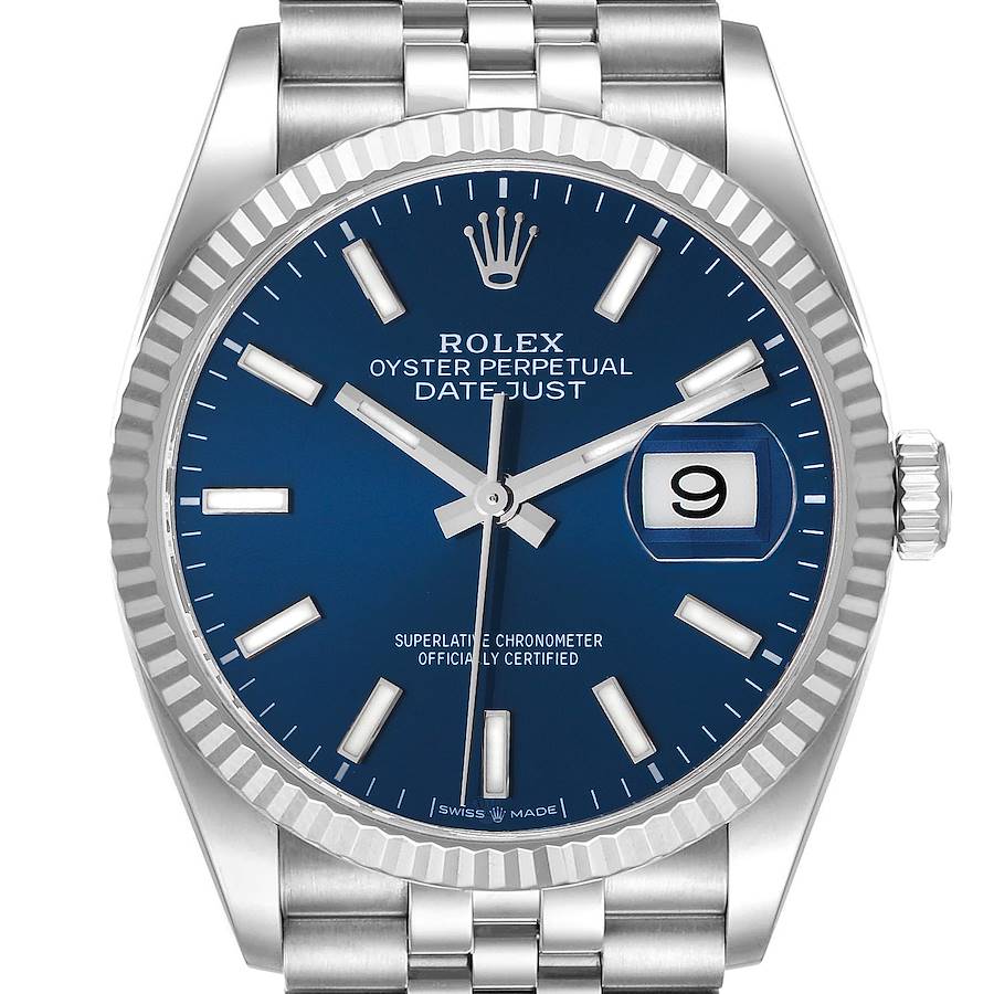 The image shows a front angle of a Rolex Datejust watch, highlighting its blue dial, fluted bezel, and jubilee bracelet.