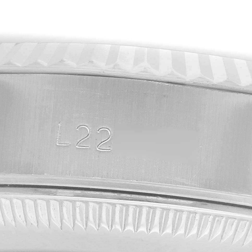 The image shows a close-up of the fluted bezel and side engravings of a Rolex Datejust 69174 Women's Stainless Steel Silver Dial watch.