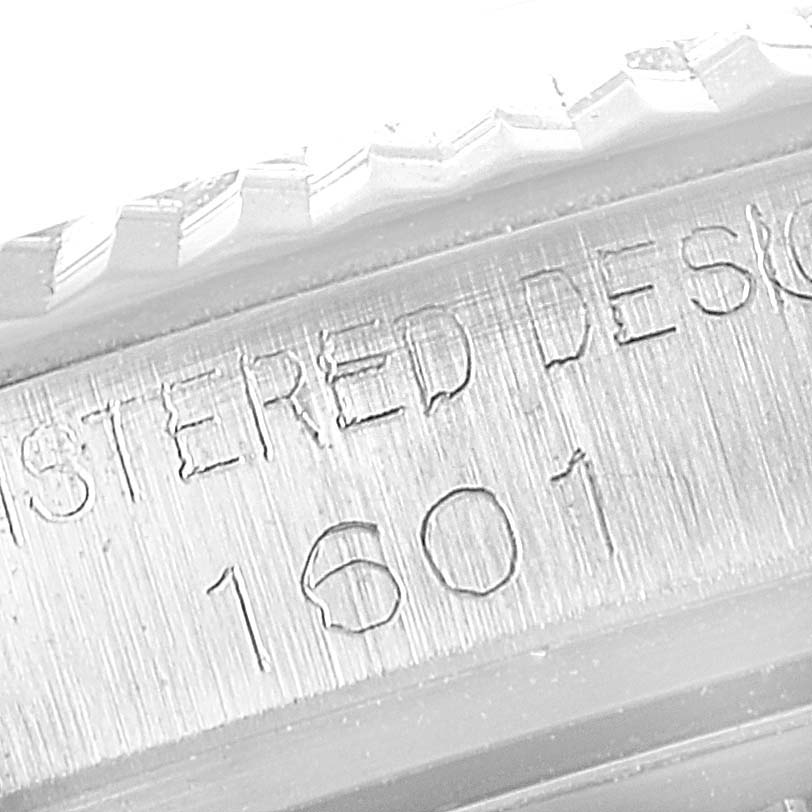 The image shows a close-up of the bezel and case side detail of a Rolex Vintage Collection 1601 Men
s Stainless Steel White Dial 1601 Men
s Stainless Steel White Dial model, featuring registered design markings and the number 1601.