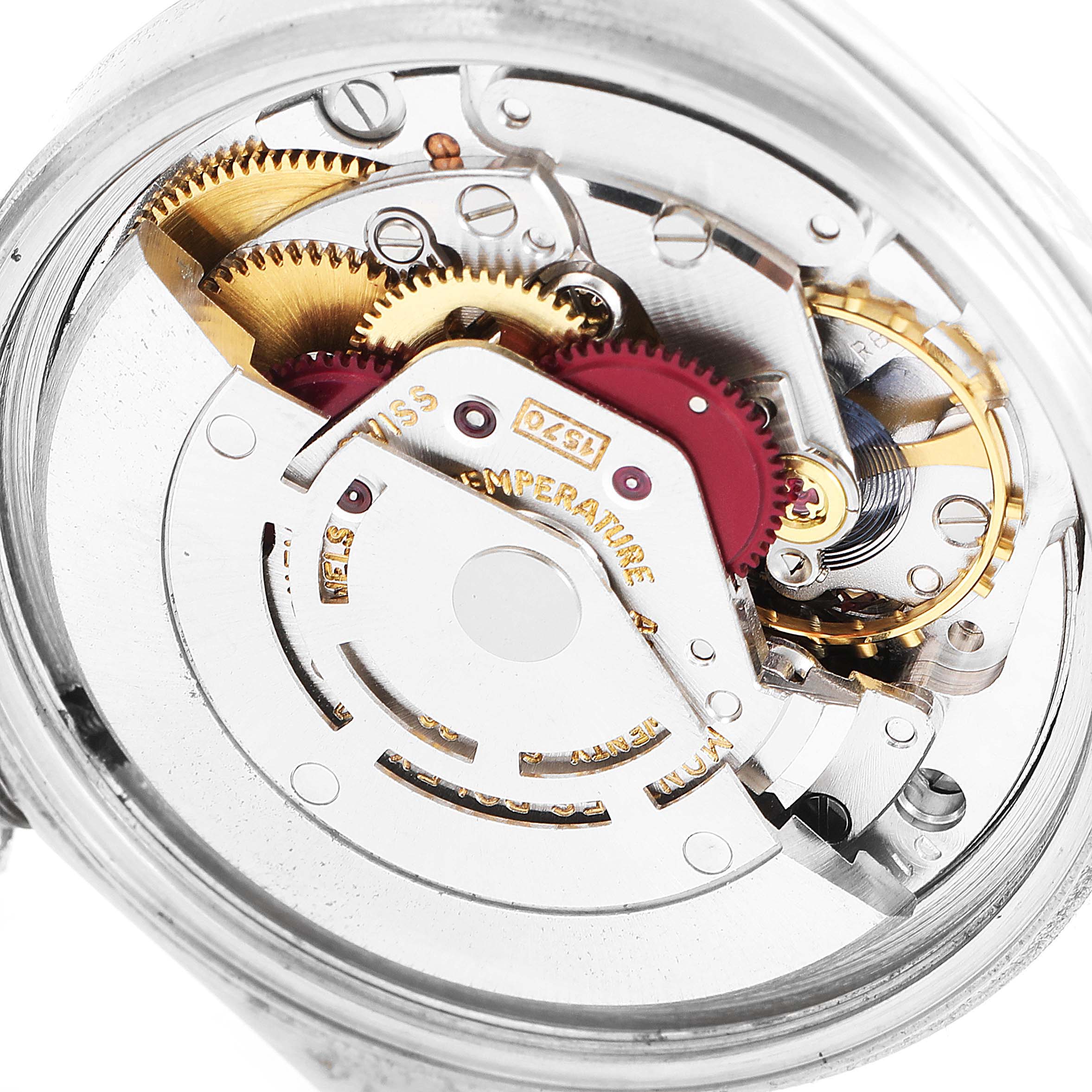 The image shows a close-up of the movement parts in the Rolex Vintage Collection 1601 Men
s Stainless Steel White Dial 1601 Men
s Stainless Steel White Dial model watch, highlighting gears and components.