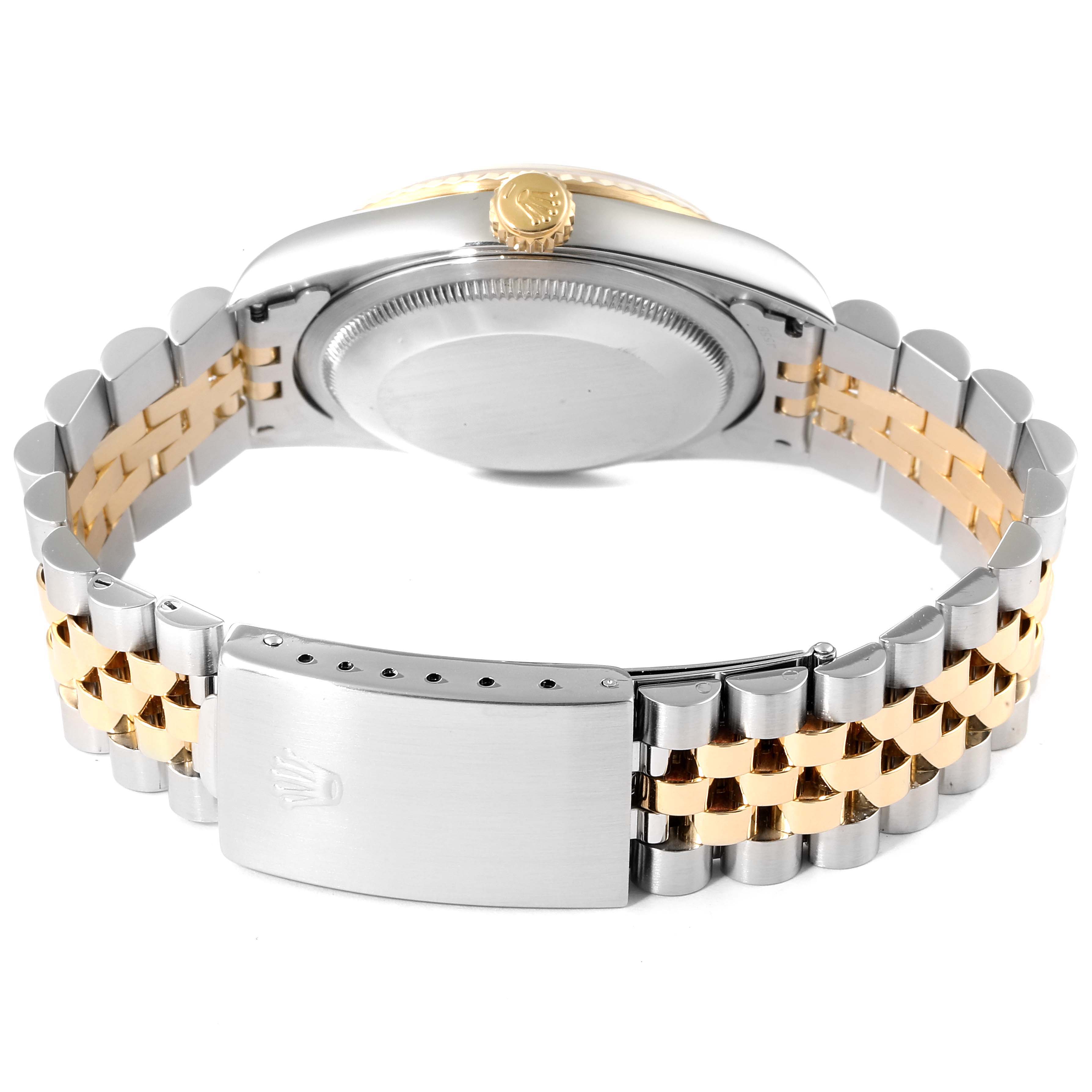 This image shows the back case and bracelet, including the clasp, of a Rolex Datejust 16233 Men's Steel and Gold (two tone) Champagne Dial 16233 Men's Steel and Gold (two tone) Champagne Dial model watch.