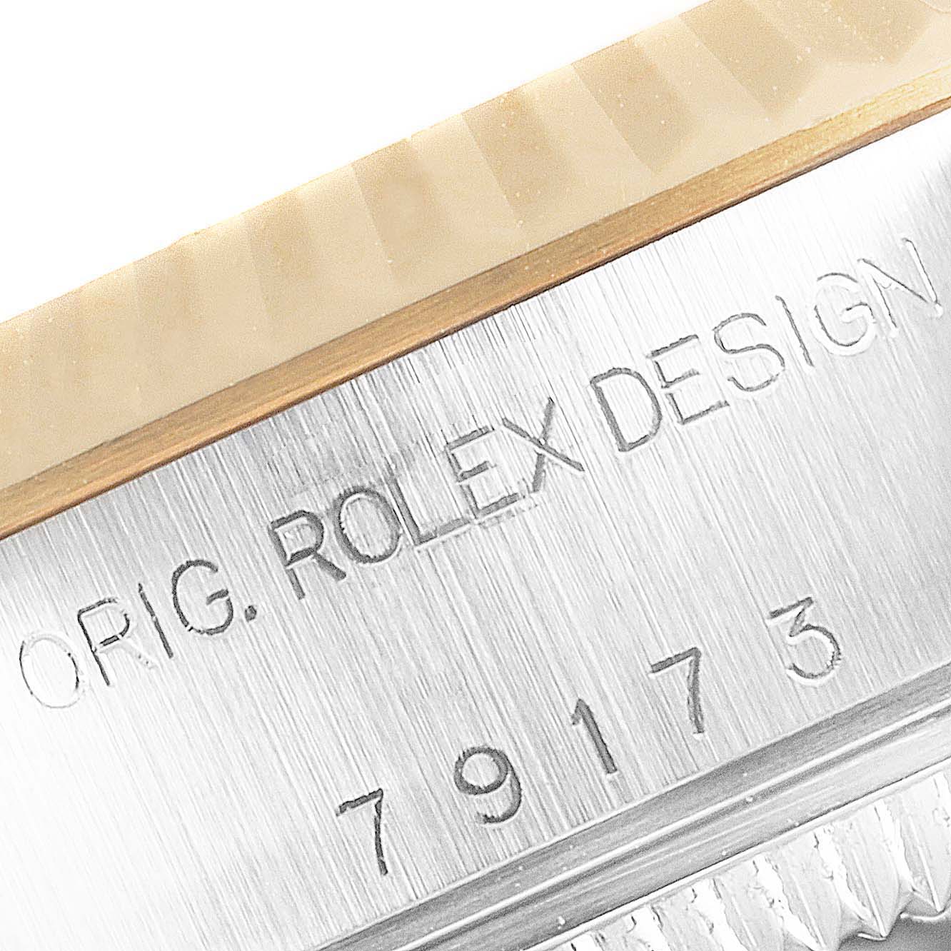This image shows a close-up of the serial number and "ORIG. ROLEX DESIGN" engraving on the case of the Datejust model by Rolex.