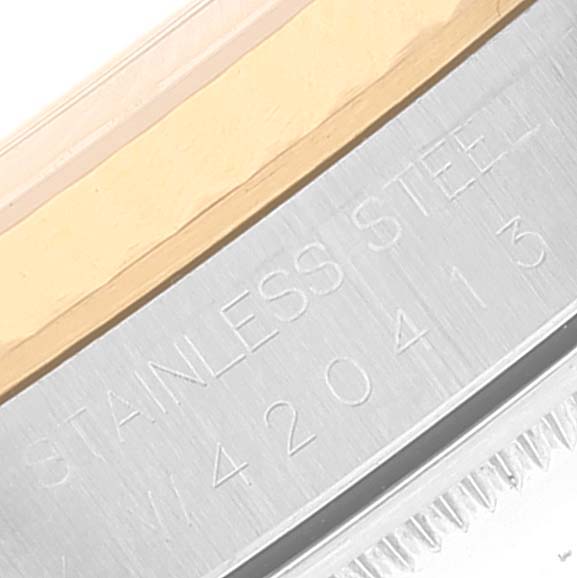 This image shows a close-up angle of the bezel and case side of a Rolex Datejust 16233 Men
s Stainless Steel Champagne Dial 16233 Men
s Stainless Steel Champagne Dial watch, highlighting the "STAINLESS STEEL" engraving.