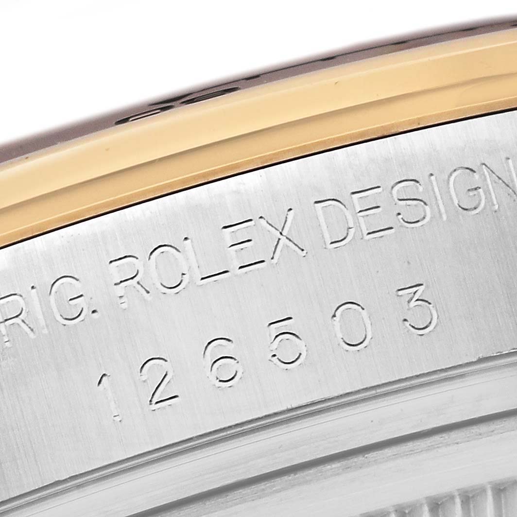 The image shows a close-up of the engravings on the case of a Rolex Daytona 126503 Men
s Steel and Gold (two tone) Black Dial, highlighting the model and serial number.