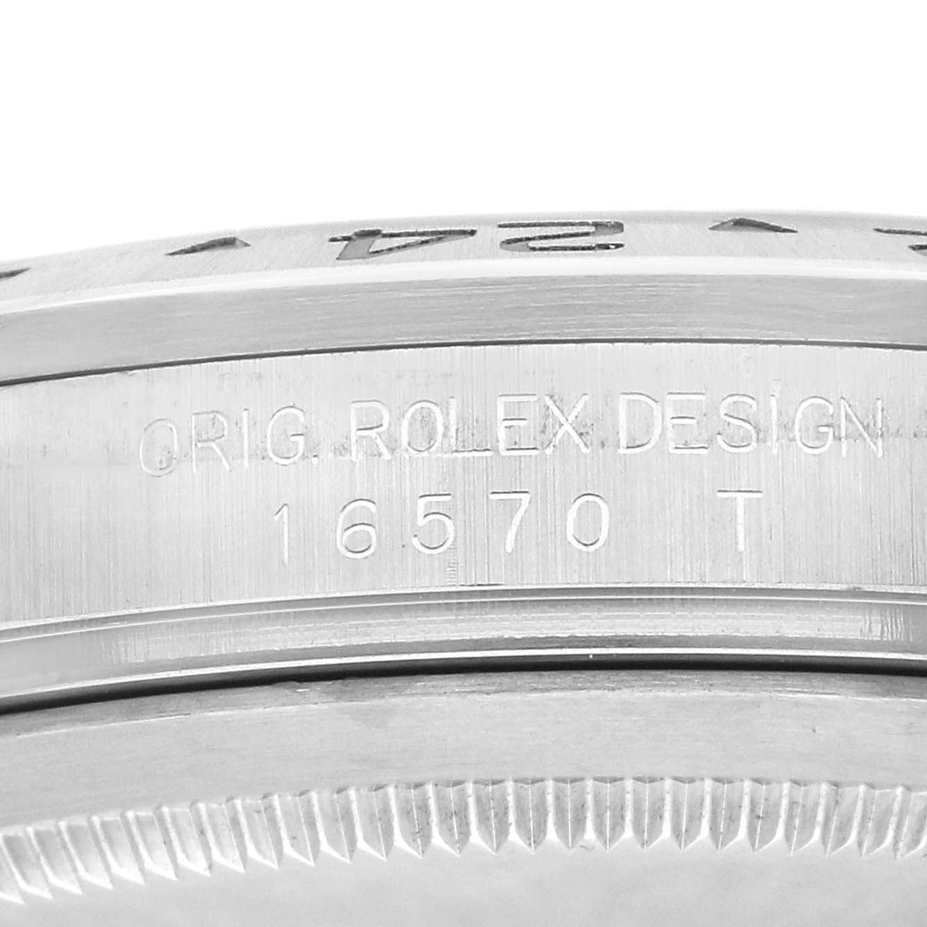 The image shows a close-up of the side of a Rolex Explorer 16570 Men
s Stainless Steel Black Dial, featuring the bezel and engraved model number 16570 T.