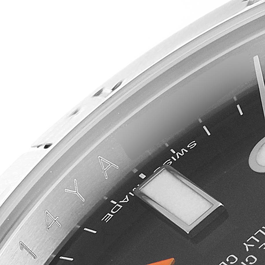 This image shows a close-up angle of the dial and bezel of a Rolex Explorer 216570 Men's Stainless Steel Black Dial 216570 Men's Stainless Steel Black Dial watch, displaying part of an hour marker and text.