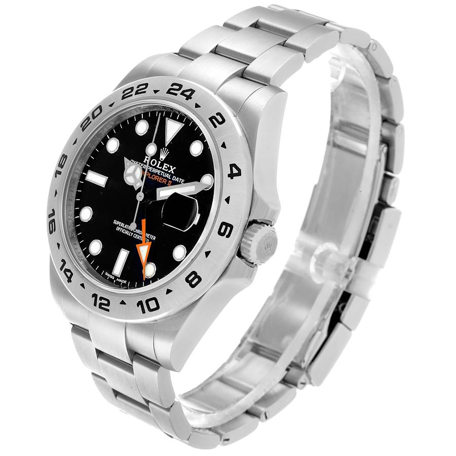 The Rolex Explorer 216570 Men's Stainless Steel Black Dial watch is shown at an angle highlighting the dial, bezel, crown, and stainless steel bracelet.