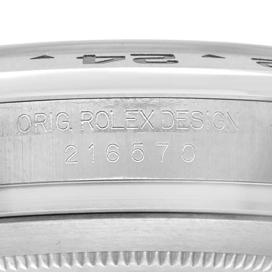 The image shows a close-up side view of the bezel and case edge of a Rolex Explorer 216570 Men's Stainless Steel Black Dial, focusing on the engraved model number.