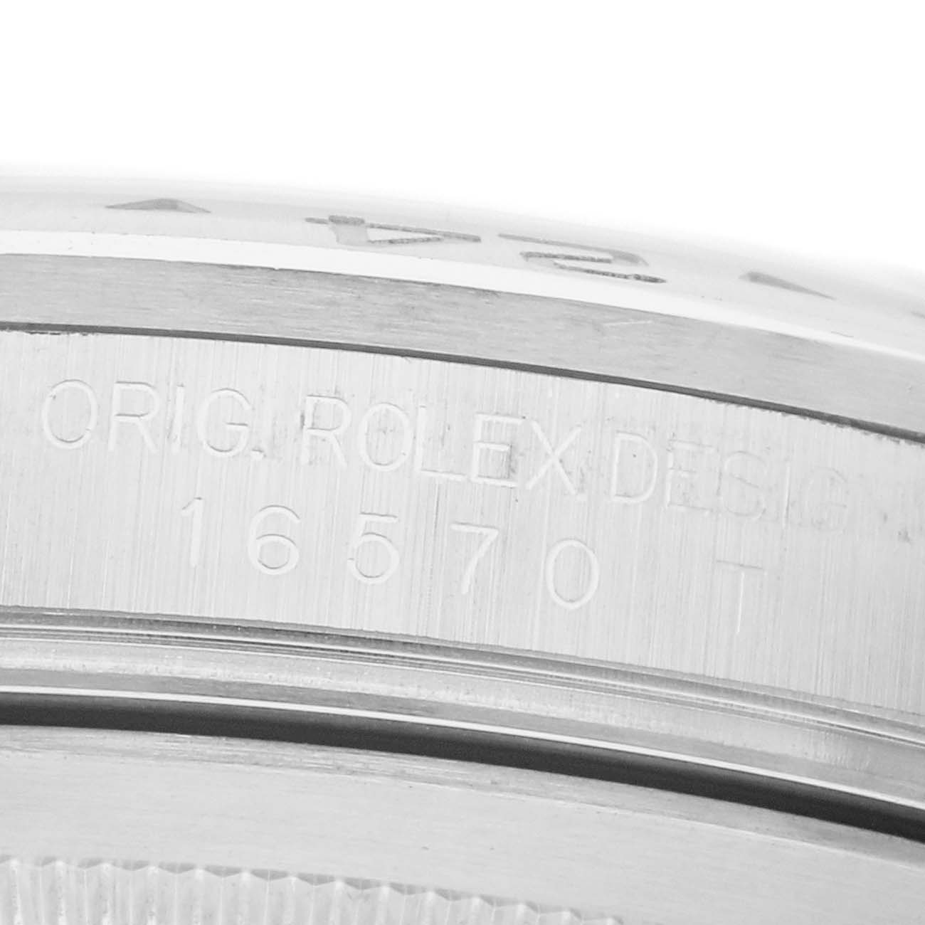 The image shows an angled close-up of the side of a Rolex Explorer 16570 Men
s Stainless Steel White Dial watch, highlighting the engraved model number 16570.