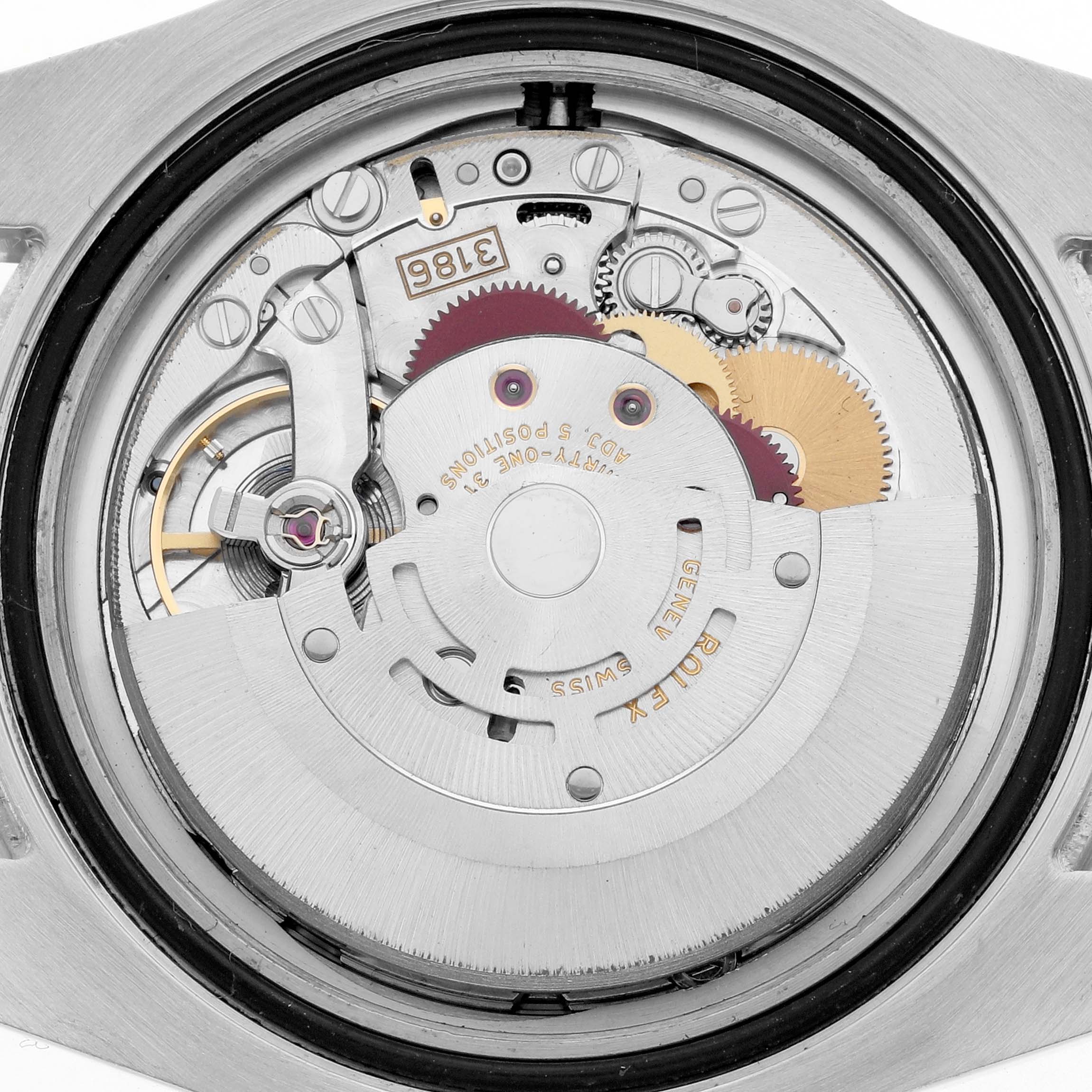 The image shows the movement of a Rolex GMT-Master 116710 Men
s Stainless Steel Black Dial from a top-down angle, highlighting gears and components.