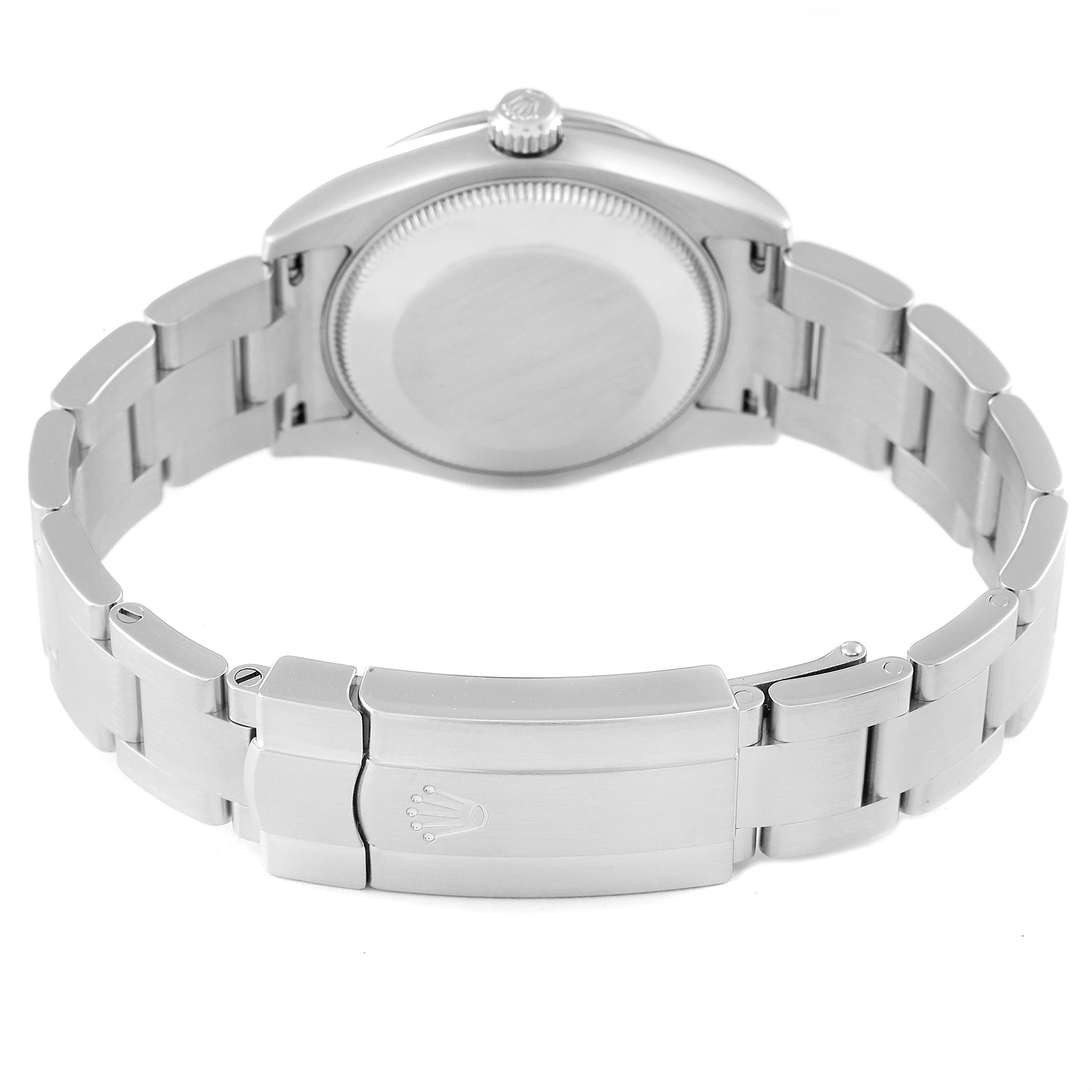 The image shows the back view of a mid-size Rolex watch, highlighting the case back, bracelet, and clasp.