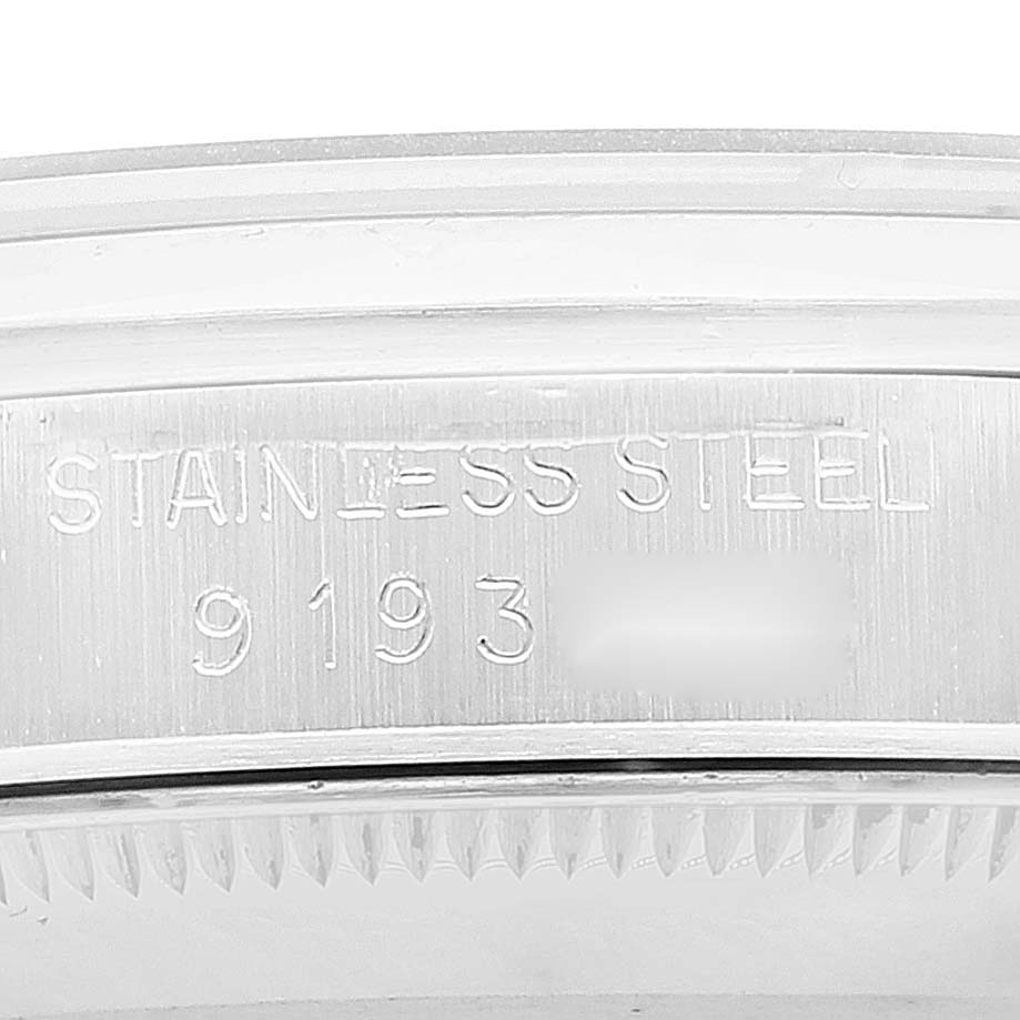This image shows a close-up of the stainless steel part with engraved details on the Mid-Size Rolex watch.