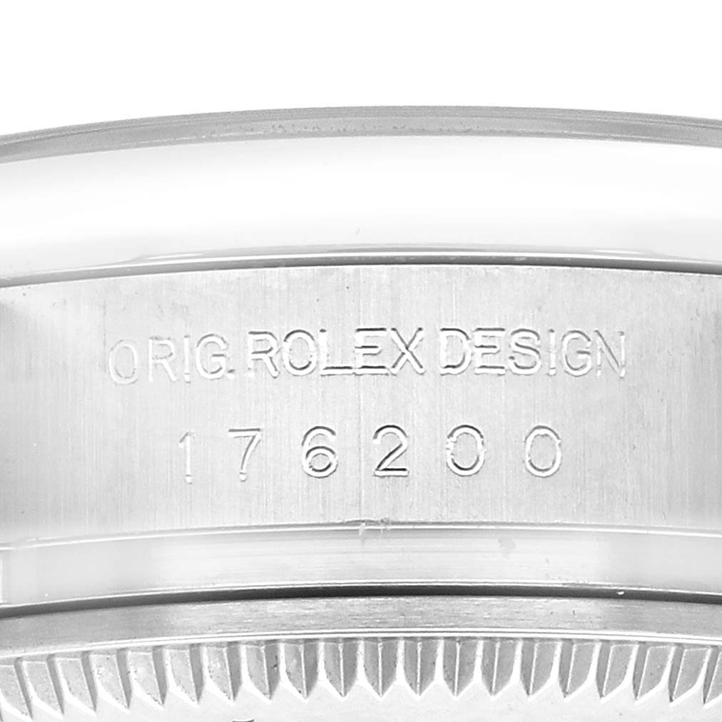 The image shows the side of a Rolex Oyster Perpetual 176200 Women
s Stainless Steel Black Dial, featuring the engravings "ORIG. ROLEX DESIGN" and the model number.