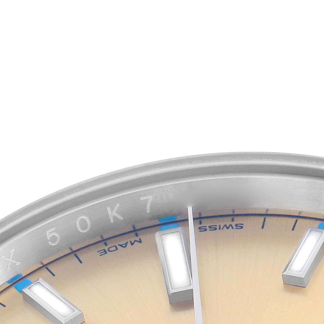 The image shows a partial view of the dial and bezel of a Rolex Oyster Perpetual 114200 Men's Stainless Steel White Dial watch, focusing on the hour markers and outer edge.