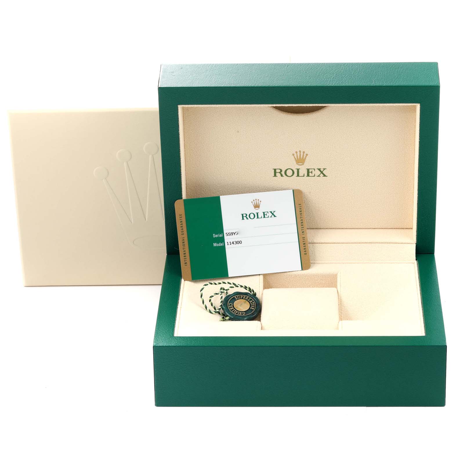 The image shows the box and accessories for a Rolex Oyster Perpetual 114300 Men's Stainless Steel Black Dial 114300 Men's Stainless Steel Black Dial model, including a warranty card and tag.