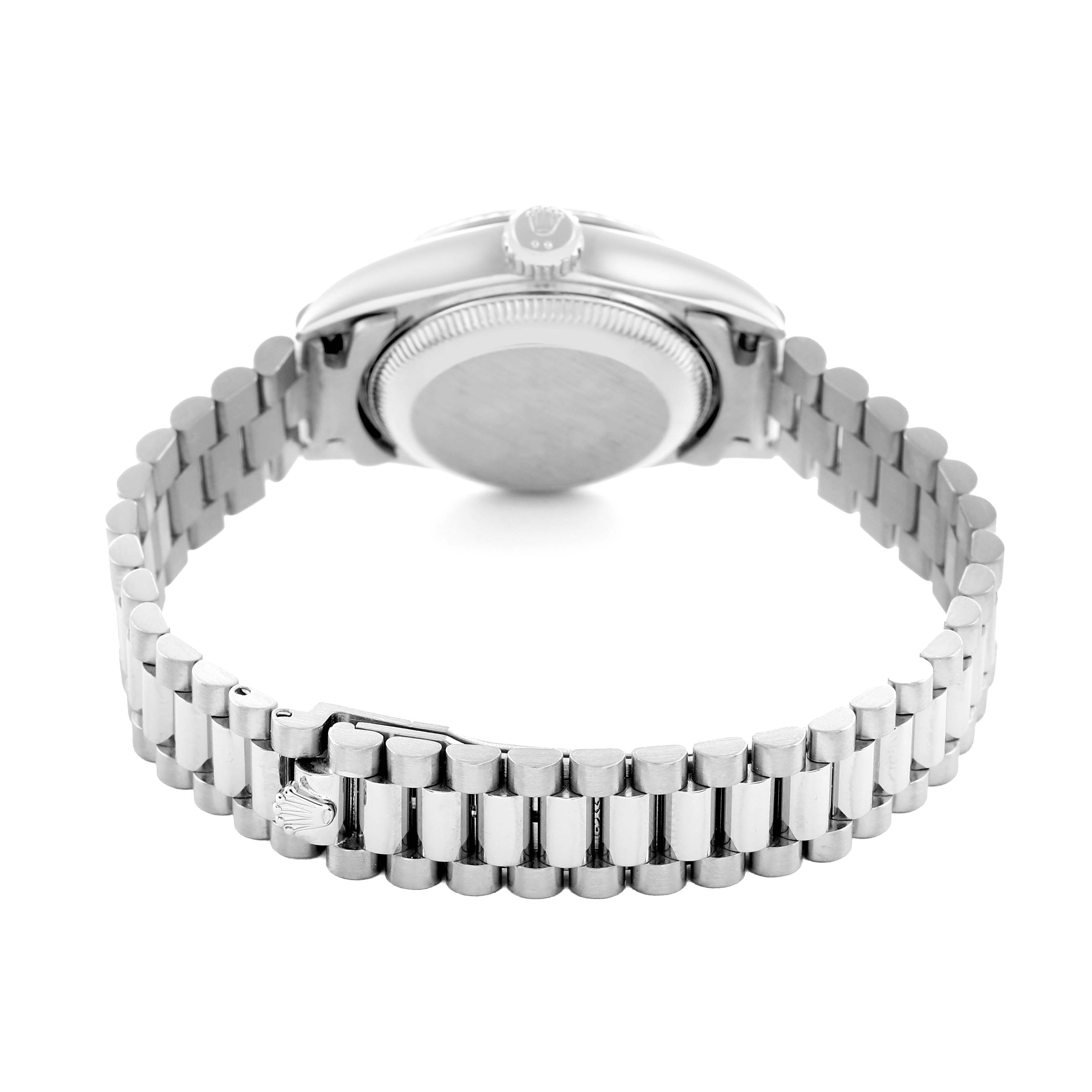 The image shows the back and side of a Rolex President 69179 Women
s White Gold Silver Dial watch, featuring the case back, crown, and bracelet clasp.