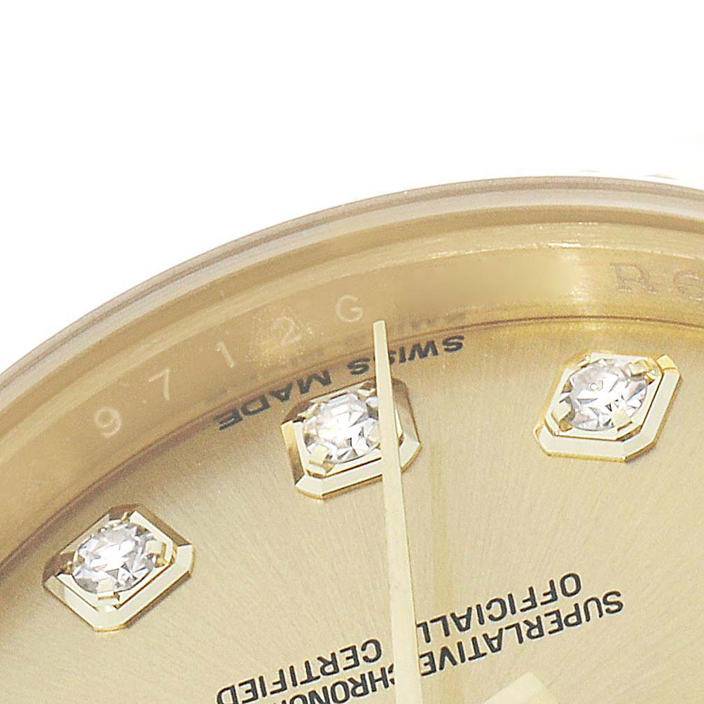 This close-up image of a Rolex President 179178 Women
s Yellow Gold Champagne Dial watch shows the dial
s diamond markers and partial view of the hands at an angled perspective.