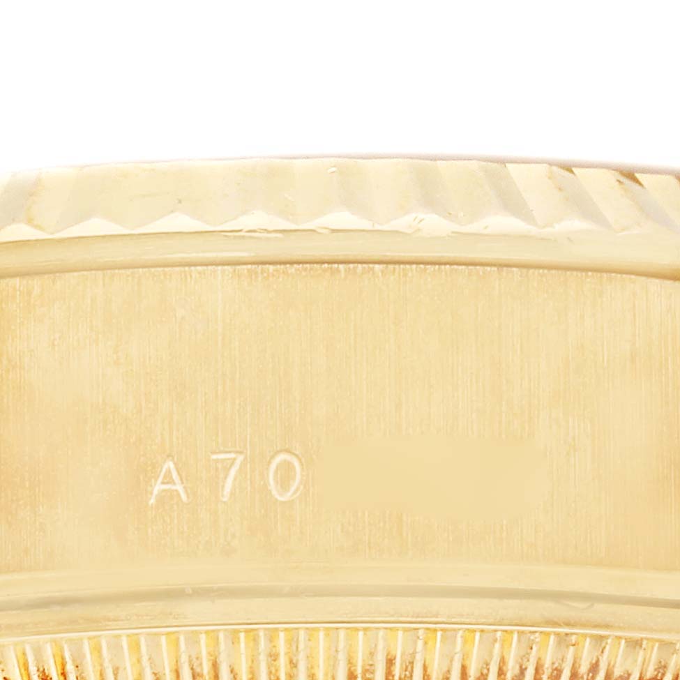 This image shows a close-up view of the side of the case and the bezel of a Rolex President 79178 Women's Yellow Gold Champagne Dial 79178 Women's Yellow Gold Champagne Dial model watch, featuring some engraving.