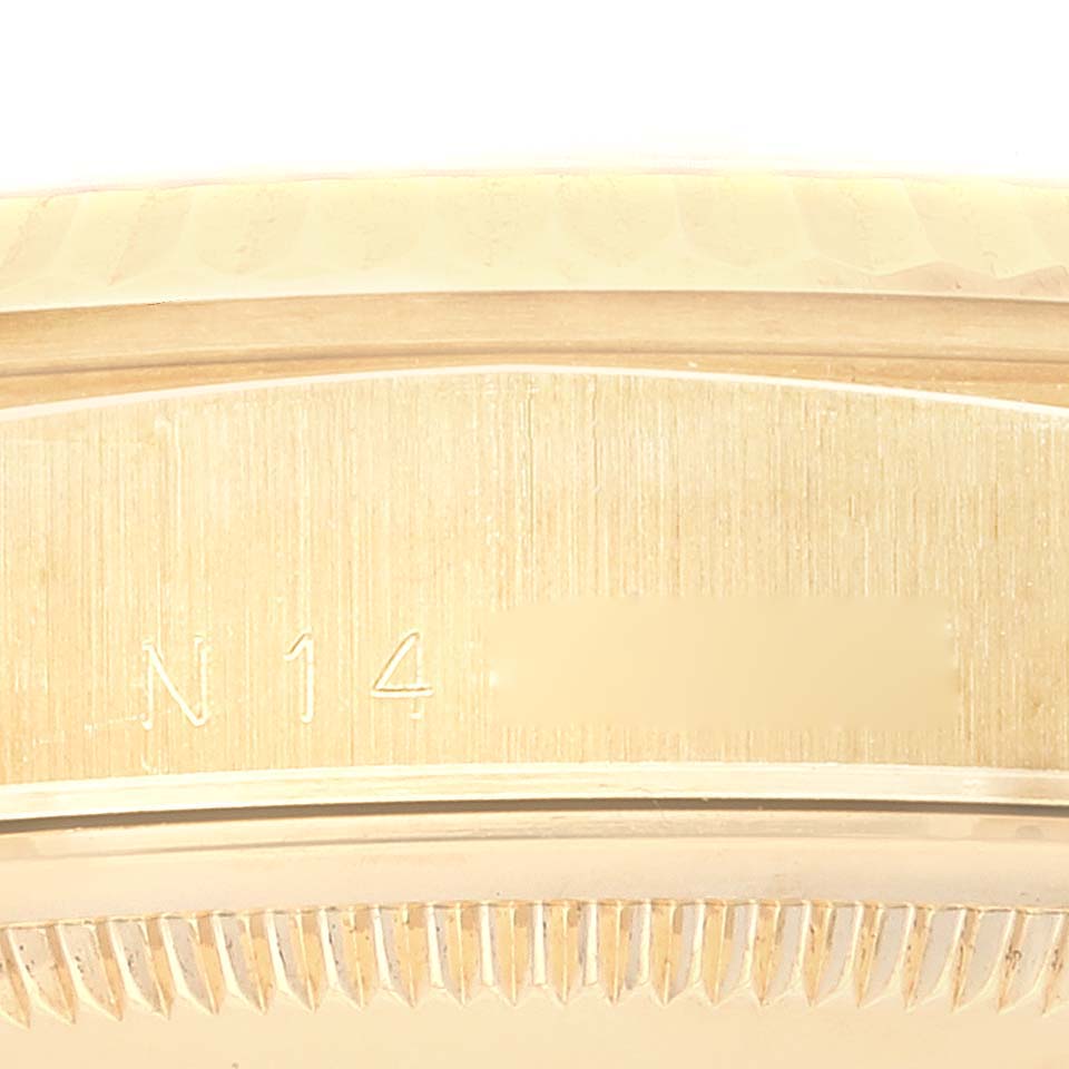 This close-up image shows the edge and part of the case back of a Rolex President 18238 Men
s Yellow Gold Champagne Dial 18238 Men
s Yellow Gold Champagne Dial watch, highlighting its serial number.