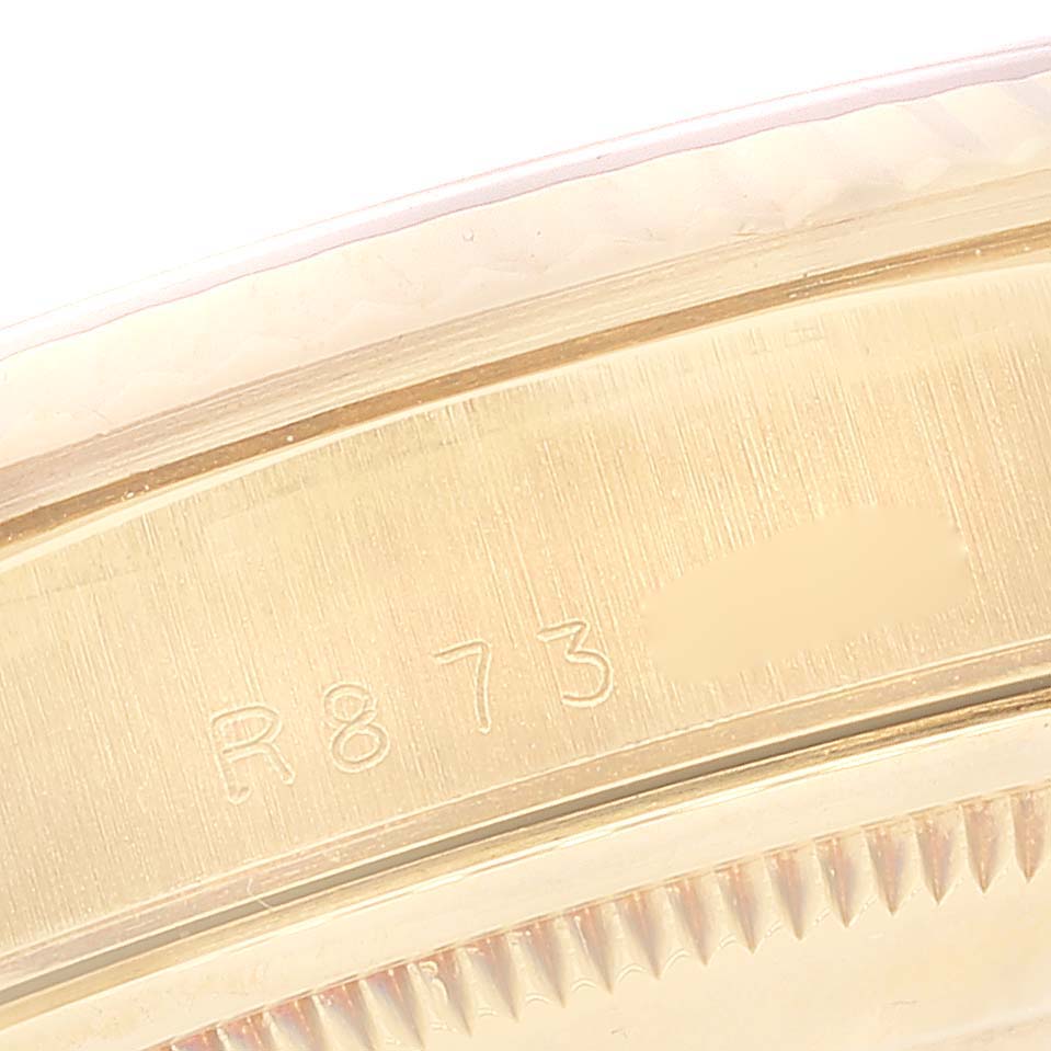 The image shows a close-up of the serial number engraving on the case back of a Rolex President 18238 Men's Yellow Gold Champagne Dial 18238 Men's Yellow Gold Champagne Dial model watch.