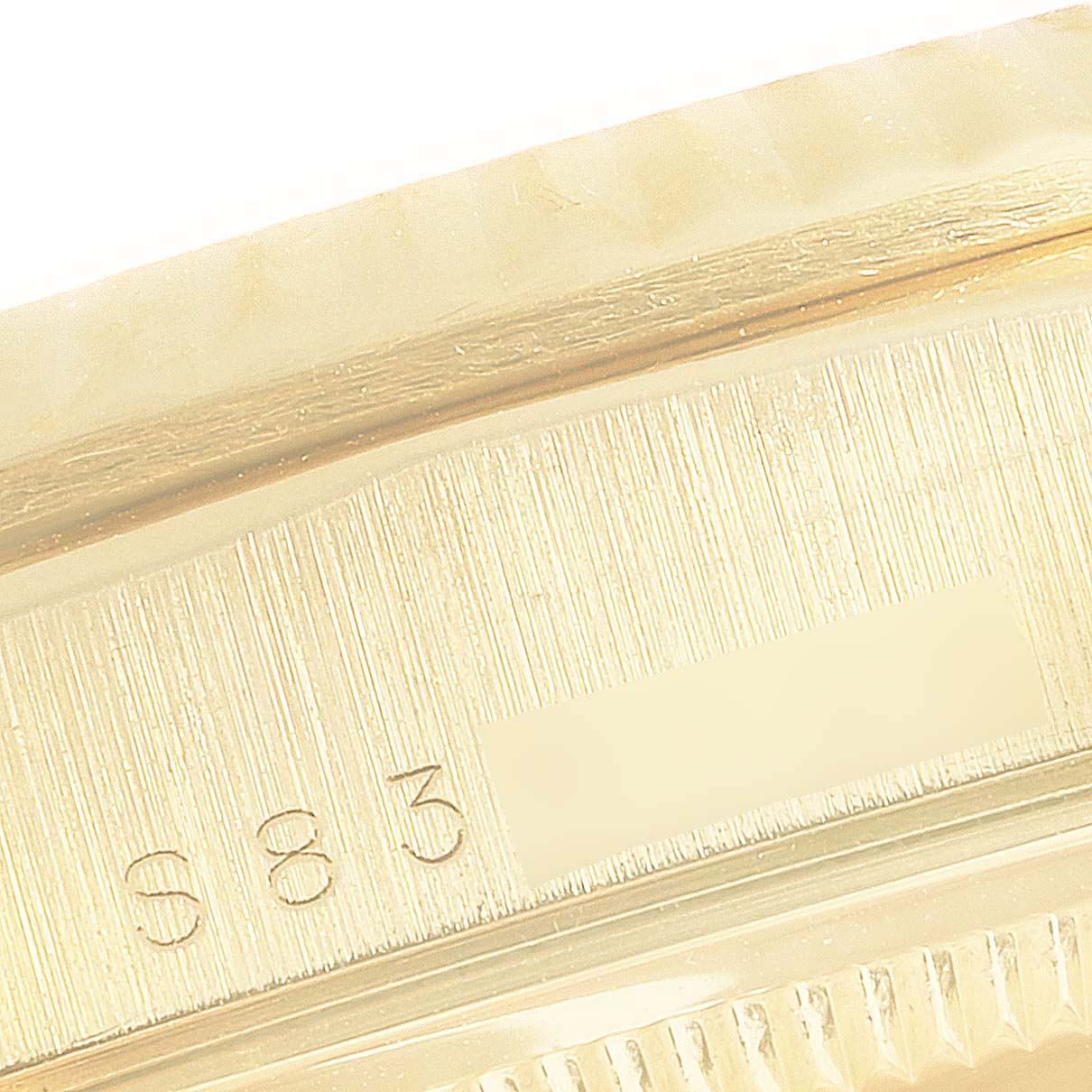This is a close-up of the serial number area on the case back of a Rolex President 18238 Men's Yellow Gold Brown Dial 18238 Men's Yellow Gold Brown Dial model watch.