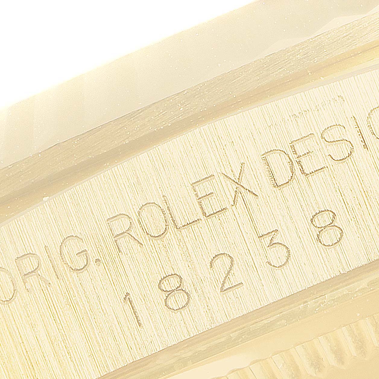 Close-up of the Rolex President 18238 Men's Yellow Gold Brown Dial 18238 Men's Yellow Gold Brown Dial model's case side showing engraved text and numbers, including the model number.